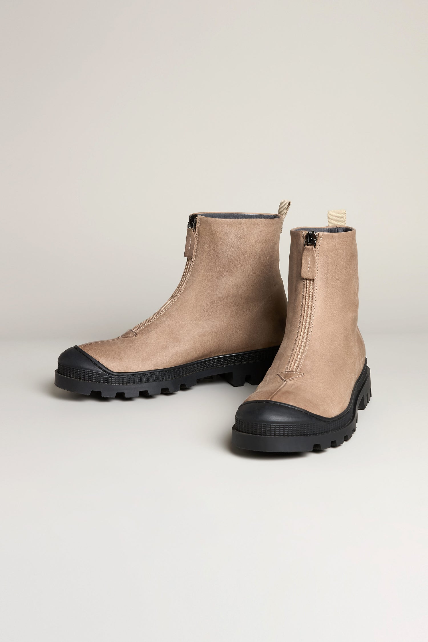 Biscotti Zip Front Leather Boots in light brown leather feature a front zip and black rubber soles, shown on a plain light background.