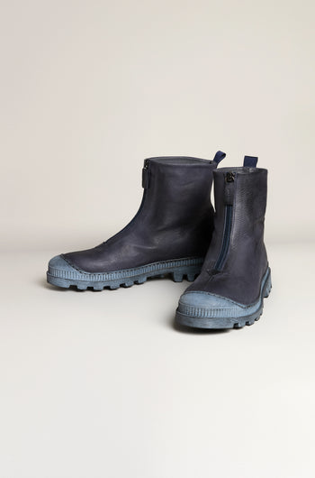 Navy Zip Front Leather Boots in handcrafted dark blue leather with side zippers and rugged blue rubber soles, displayed on a neutral background.