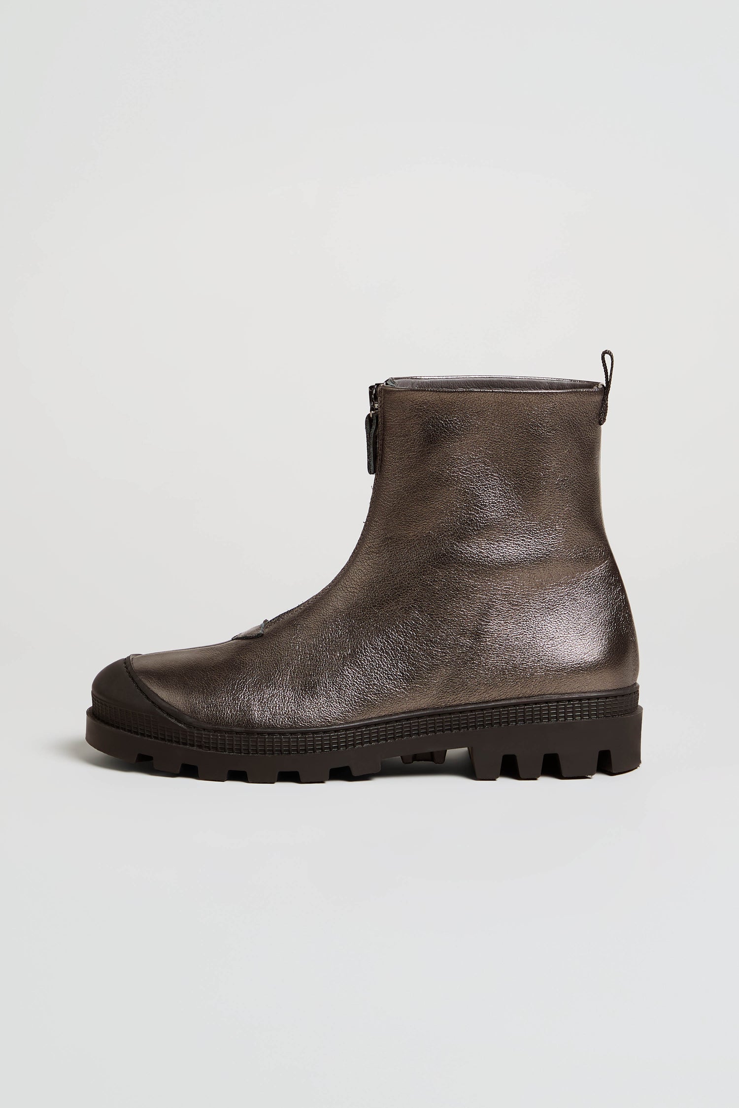 The Metallic Hematite Zip Front Leather Boots, crafted from metallic leather in a striking dark brown shade, are displayed on a plain light background. They feature a chunky tread sole and a convenient side zipper for easy wear.
