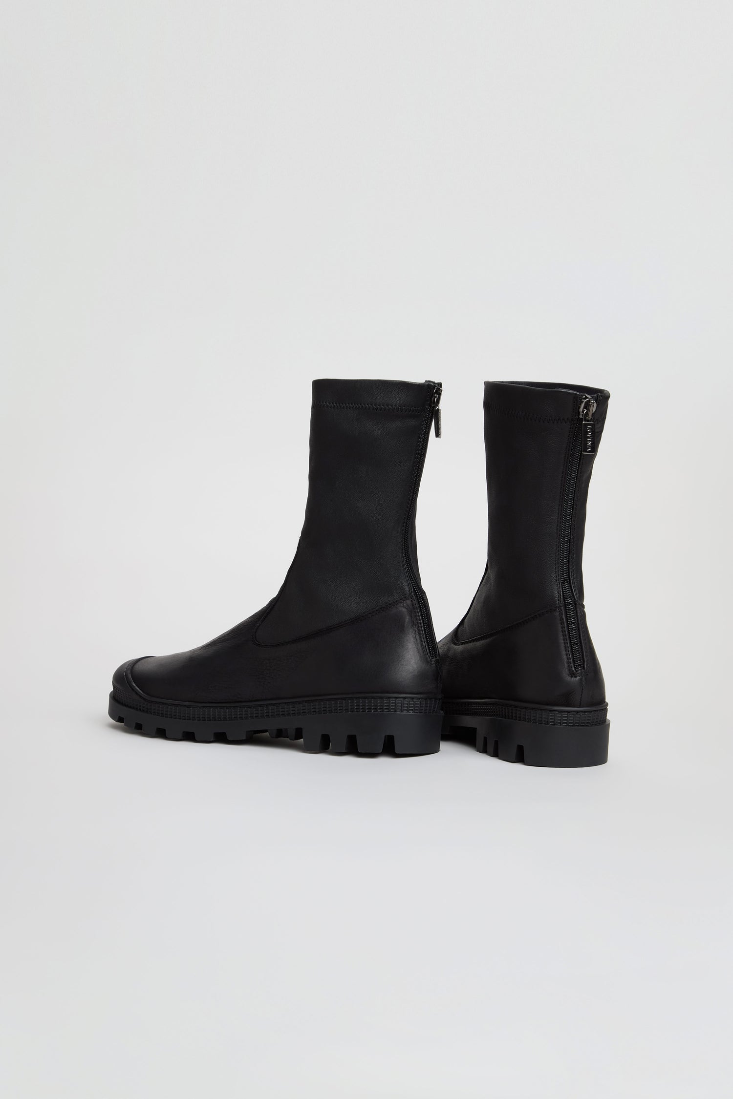 Two Stitch Detail Napa Leather Stretch Boots in black, featuring chunky soles and rear zippers, handmade in Italy, displayed on a plain light background.