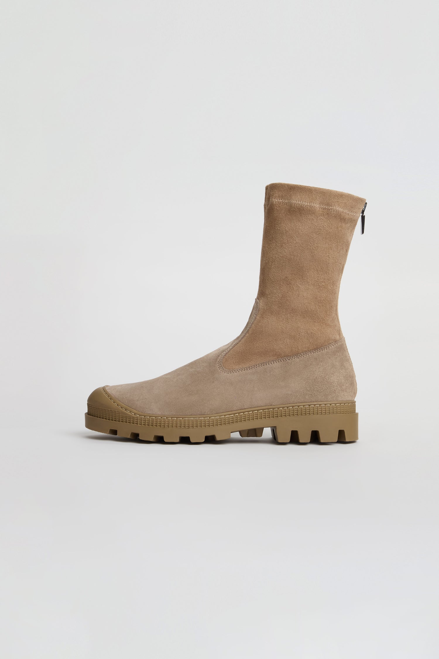 The Stitch Detail Suede Stretch Boots are tan suede mid-calf boots featuring a chunky rubber sole, side zipper, and rounded toe, expertly handmade in Italy and displayed on a plain white background.