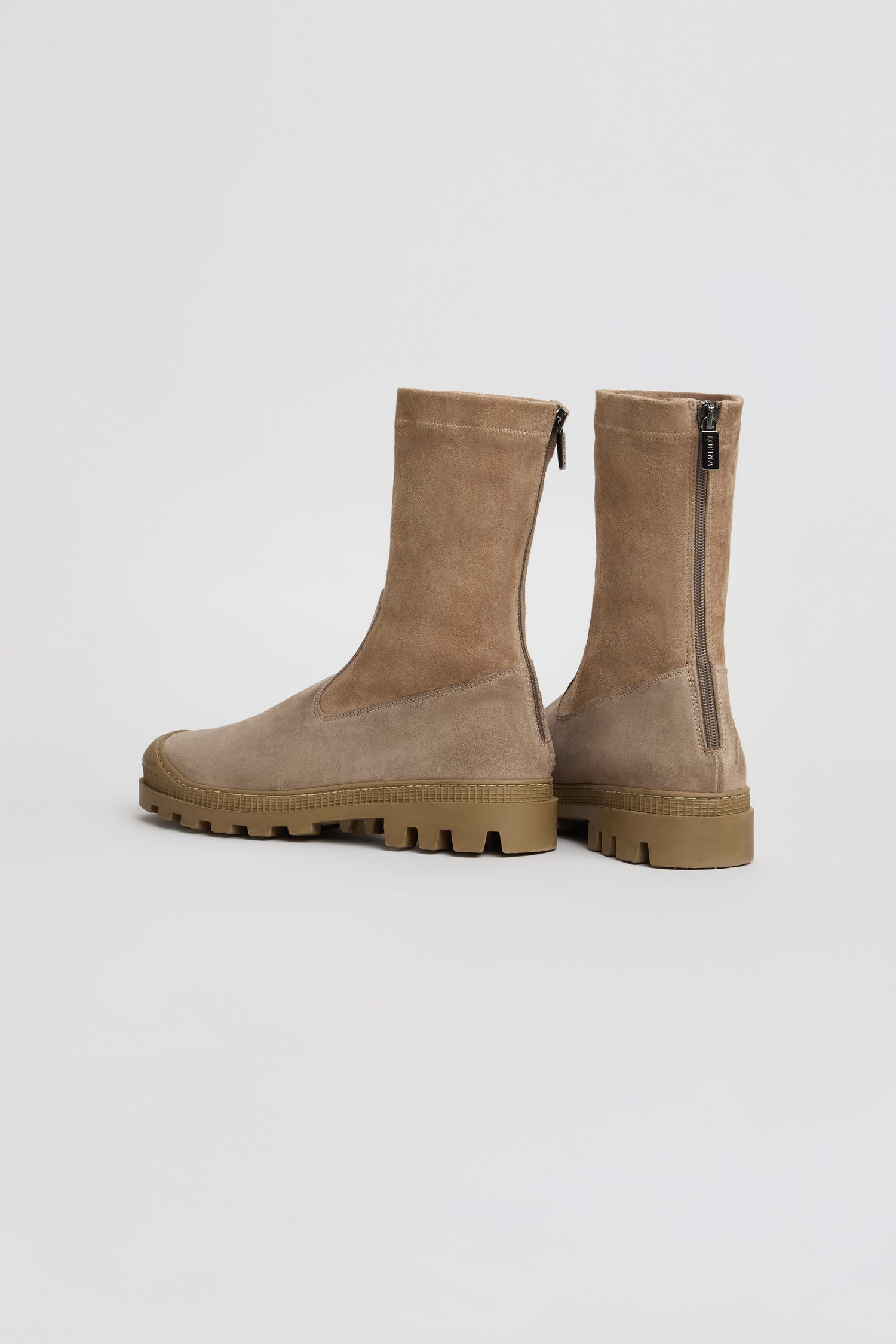 Stitch Detail Suede Stretch Boots in tan suede feature a mid-calf height, chunky rubber soles, side zippers, and visible stitching, inspired by classic ankle boot silhouettes and displayed against a plain white background.