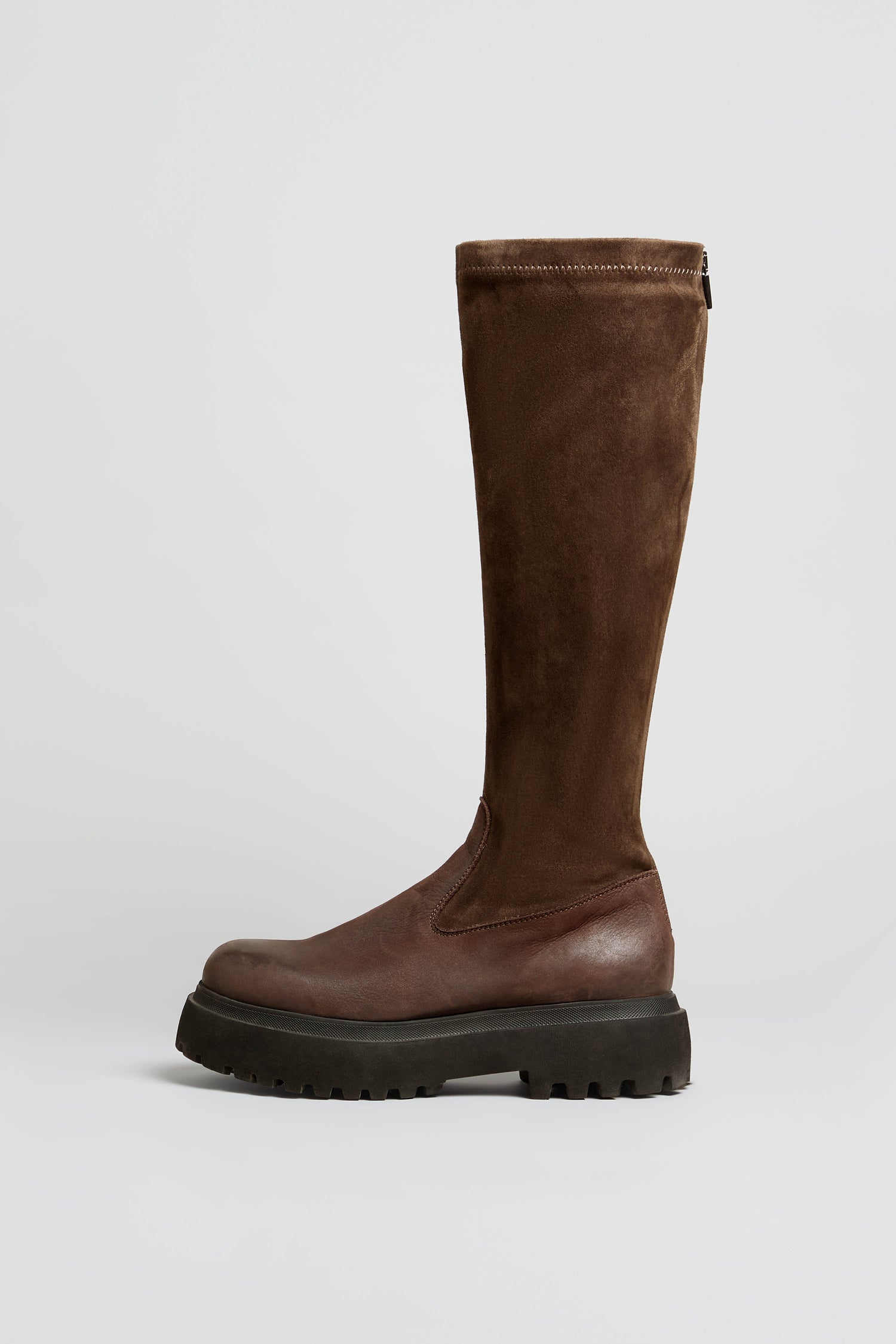 Knee High Stretch Suede Boots with a brown stretch suede upper, chocolate leather lower section, and chunky black sole, displayed against a plain white background.
