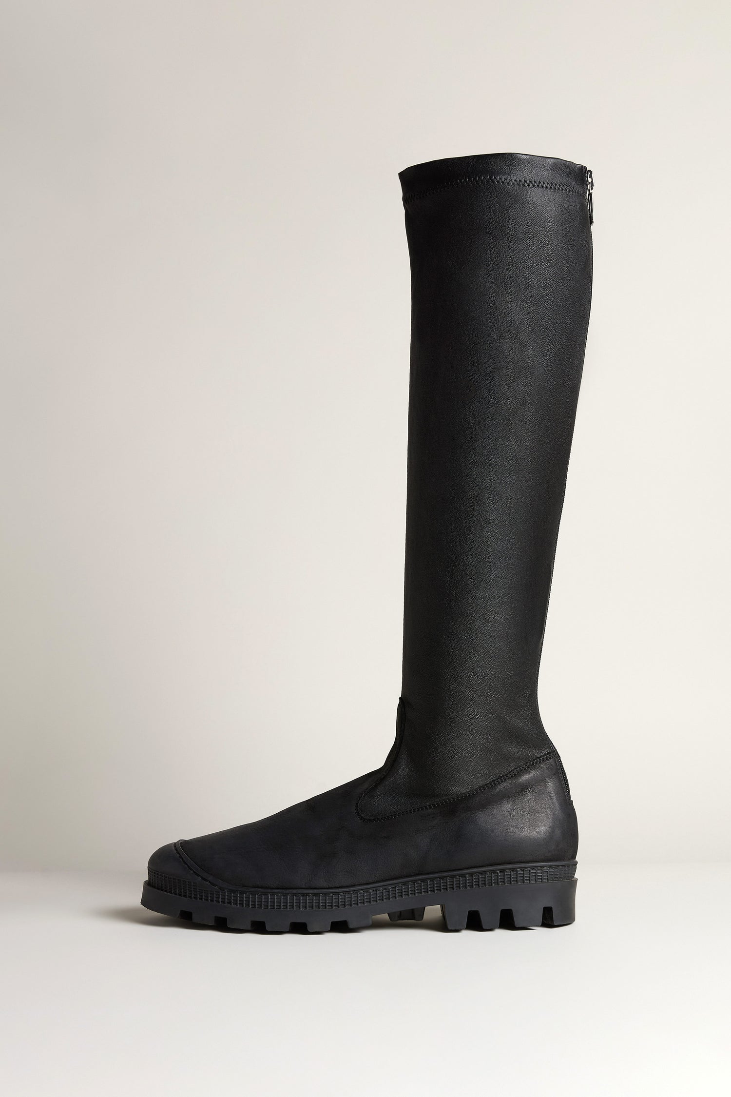 A single Stretch Long Nappa Leather Boot in black, featuring a tall silhouette and thick tread sole, crafted from sleek nappa leather and photographed against a plain light background.