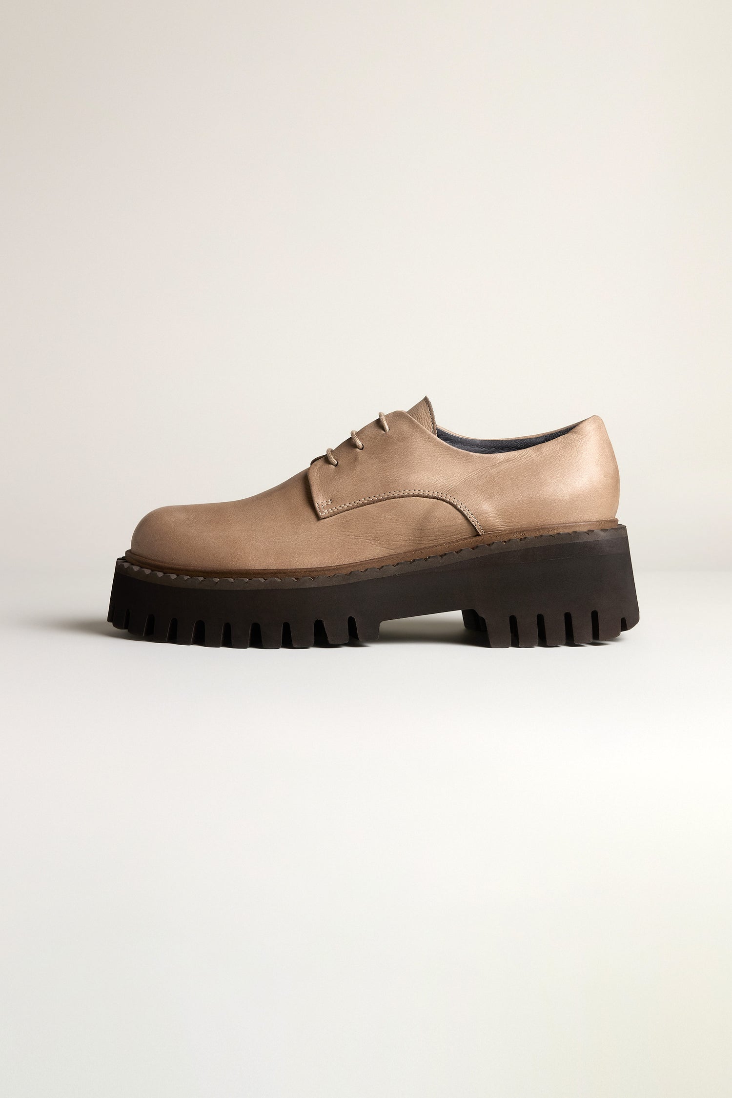 The Two Tone Lace Up Leather Brogues feature a modern tan leather design with black chunky lug soles, shown against a plain light background.