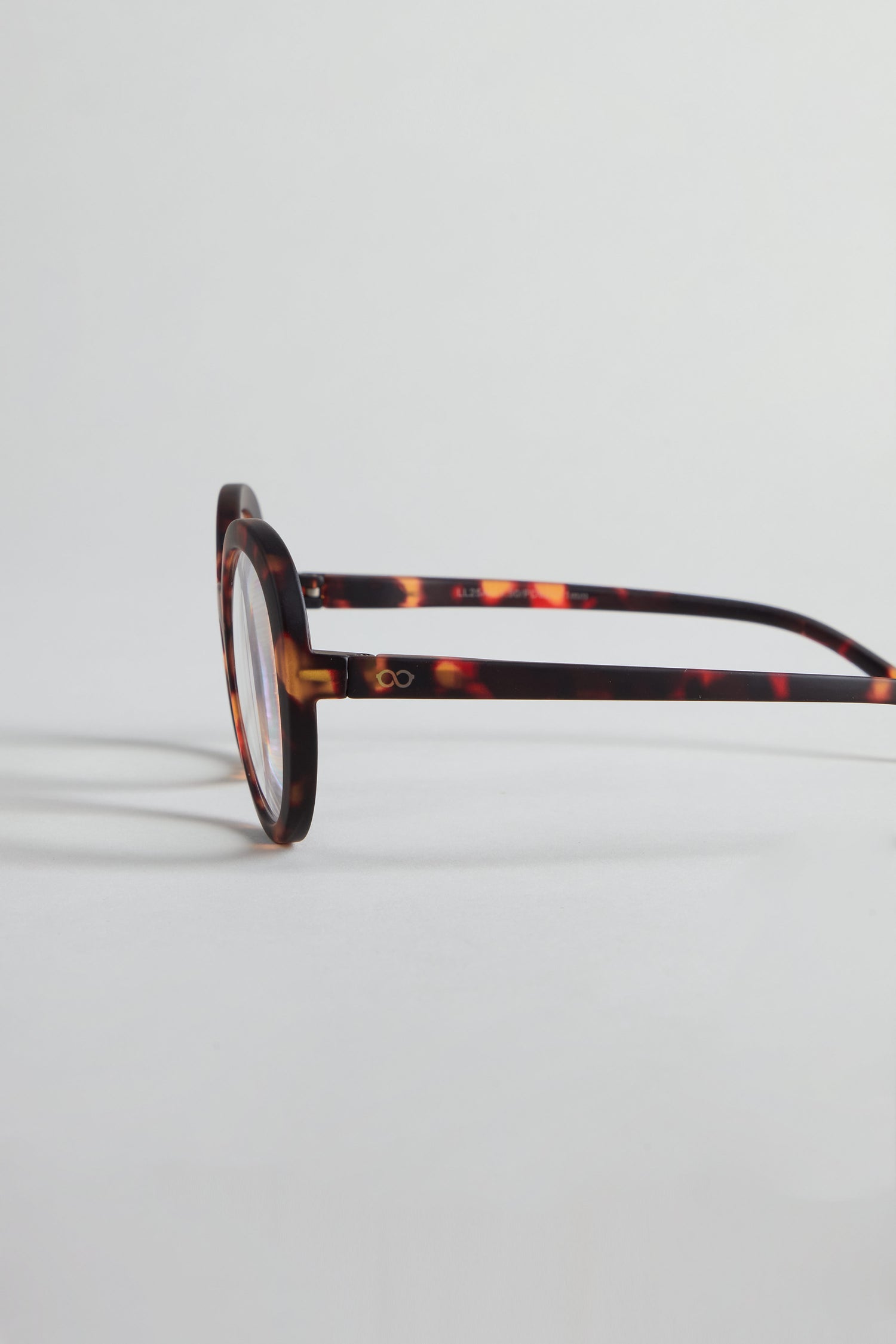 Tortoise Round Reading Glasses are displayed from the side on a plain white background, featuring optician-quality lenses for clear vision.