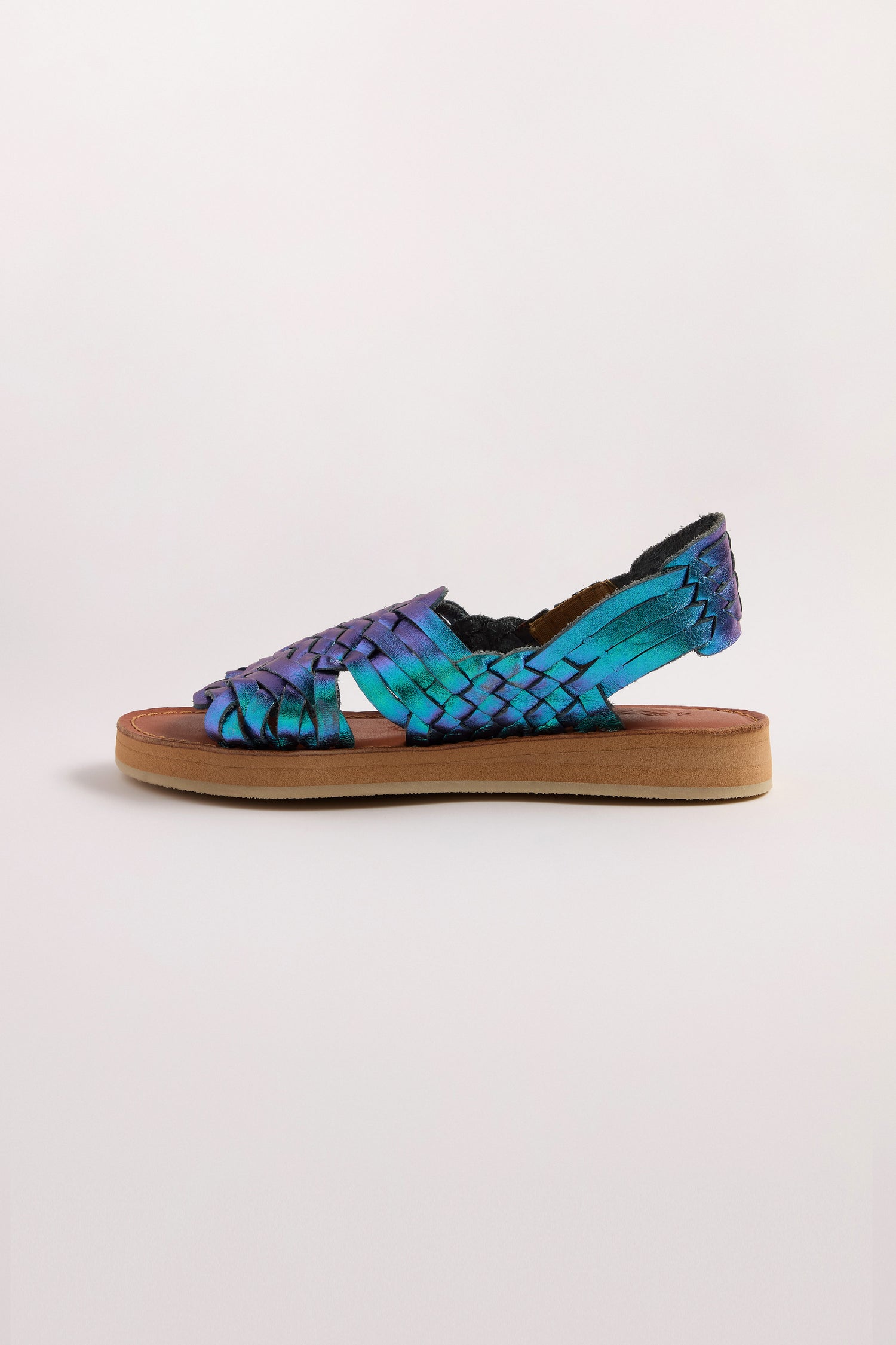 Mapache's Frida Woven Leather Sandals showcase a blue to purple gradient with a metallic magenta finish and flat brown sole, expertly handcrafted in Mexico.