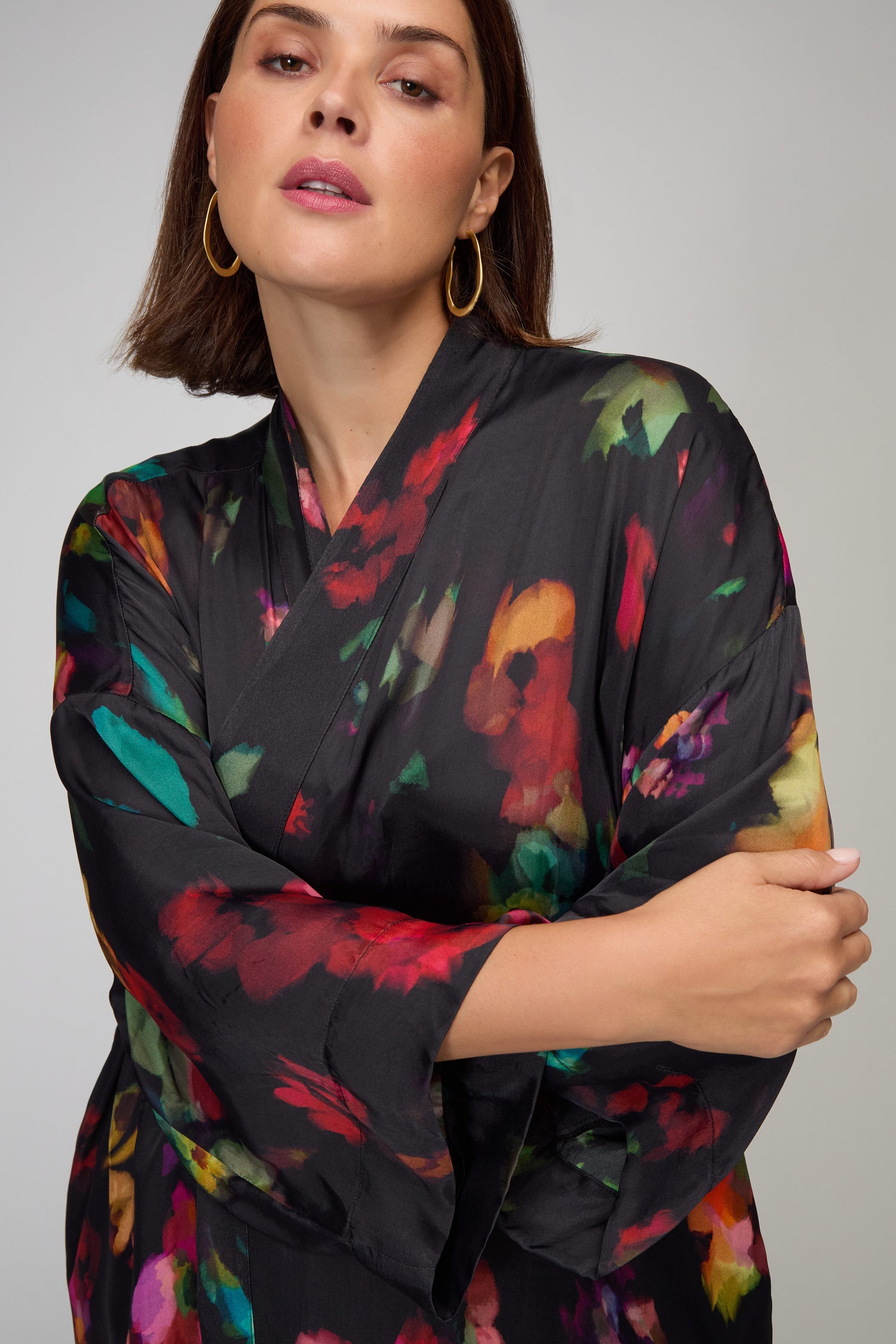 A woman models the Winter Floral Kimono, standing with her arms crossed and facing the camera against a plain background.