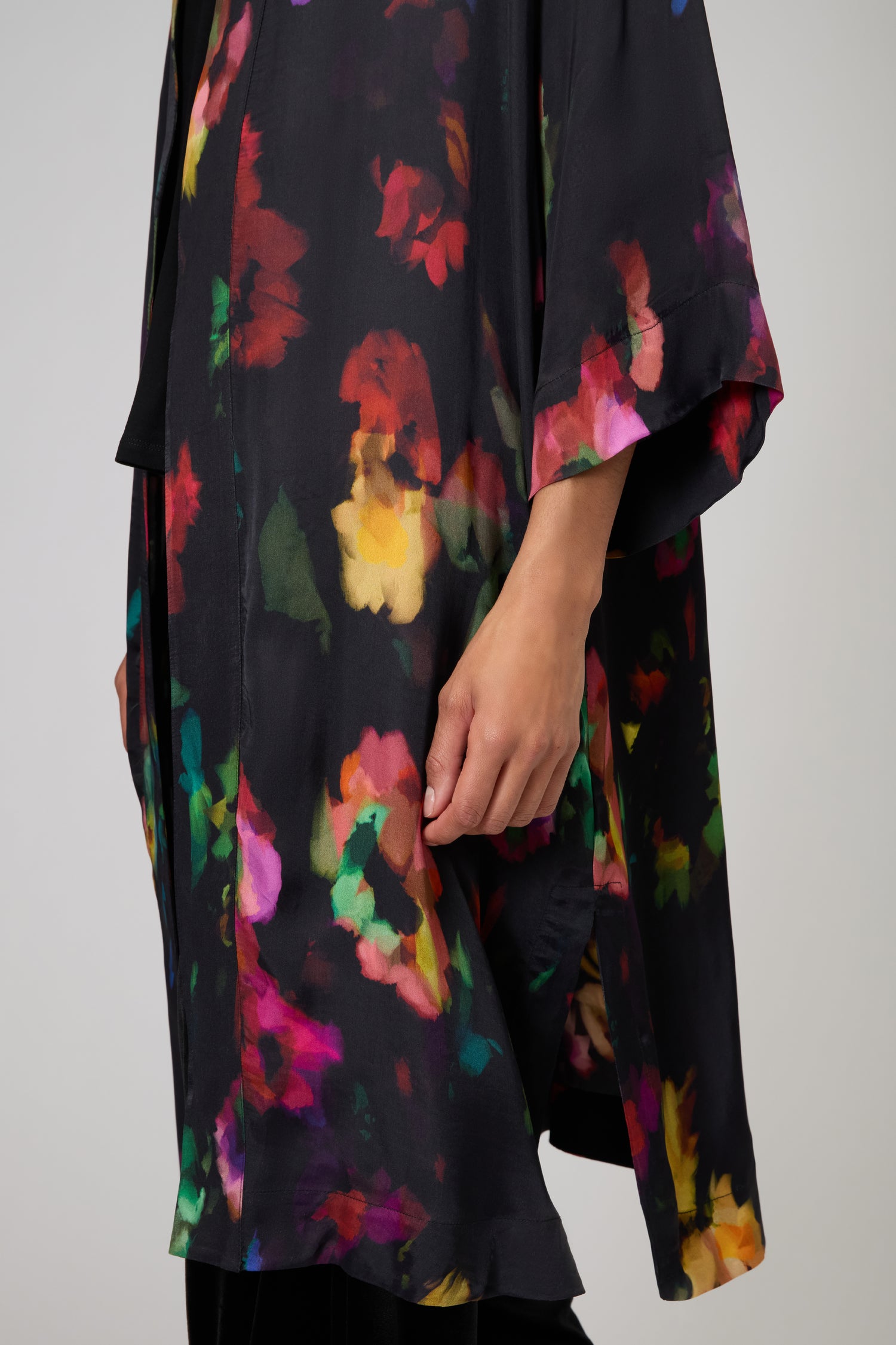 Wearing the Winter Floral Kimono, featuring a lightweight design and vibrant painterly floral print; only the torso and lower arm are visible.