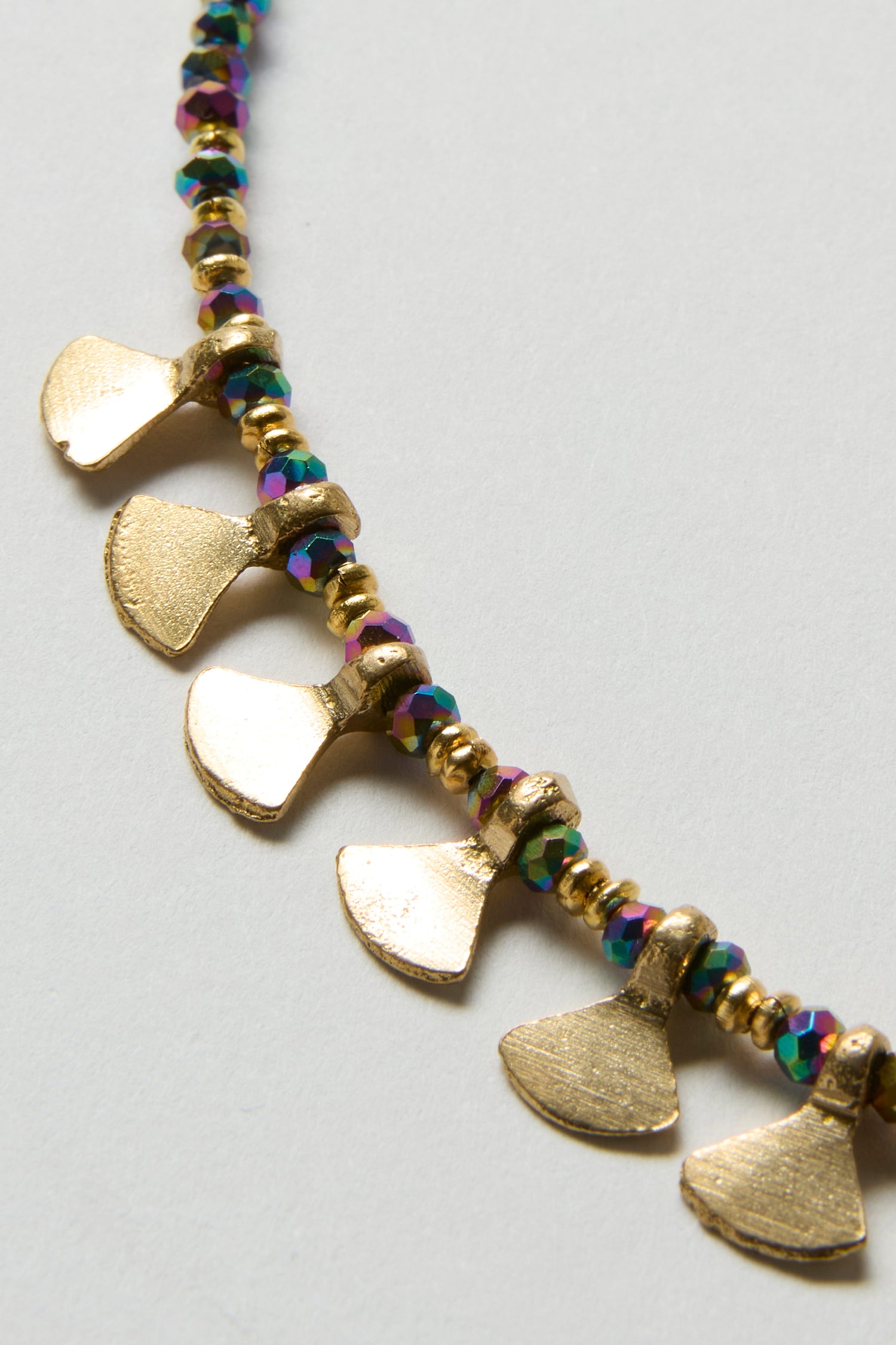 A close-up of the Short Golden Petal Necklace, featuring elegant metallic gold fan-shaped charms and multicoloured iridescent round beads on a white background.