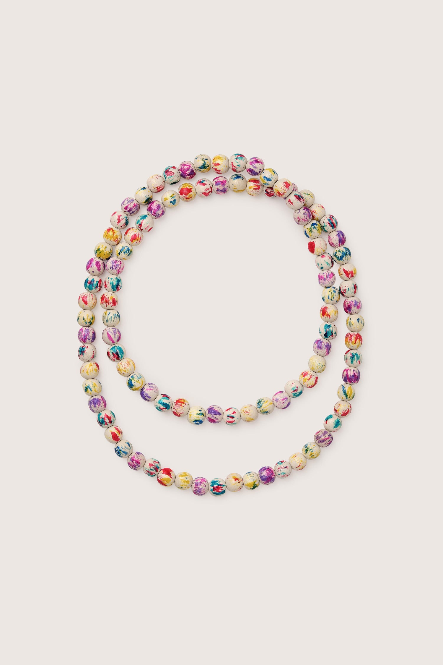 A multicolored painted spheres necklace on a white background.