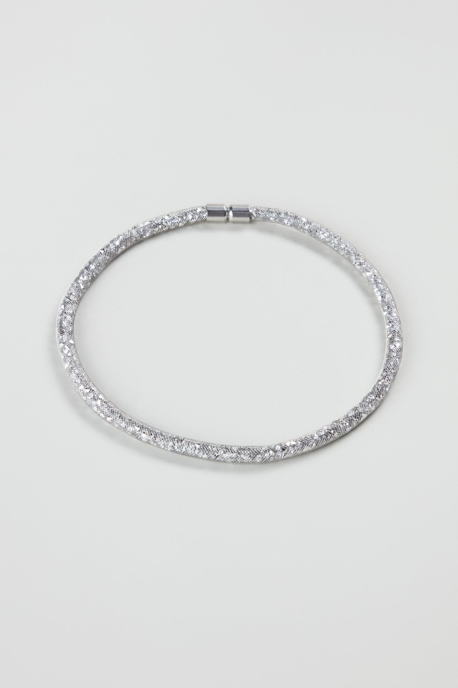 The Short Silver Diamante Necklace features a sleek design with sparkling details, reflecting modern jewellery trends and displayed on a plain white background.
