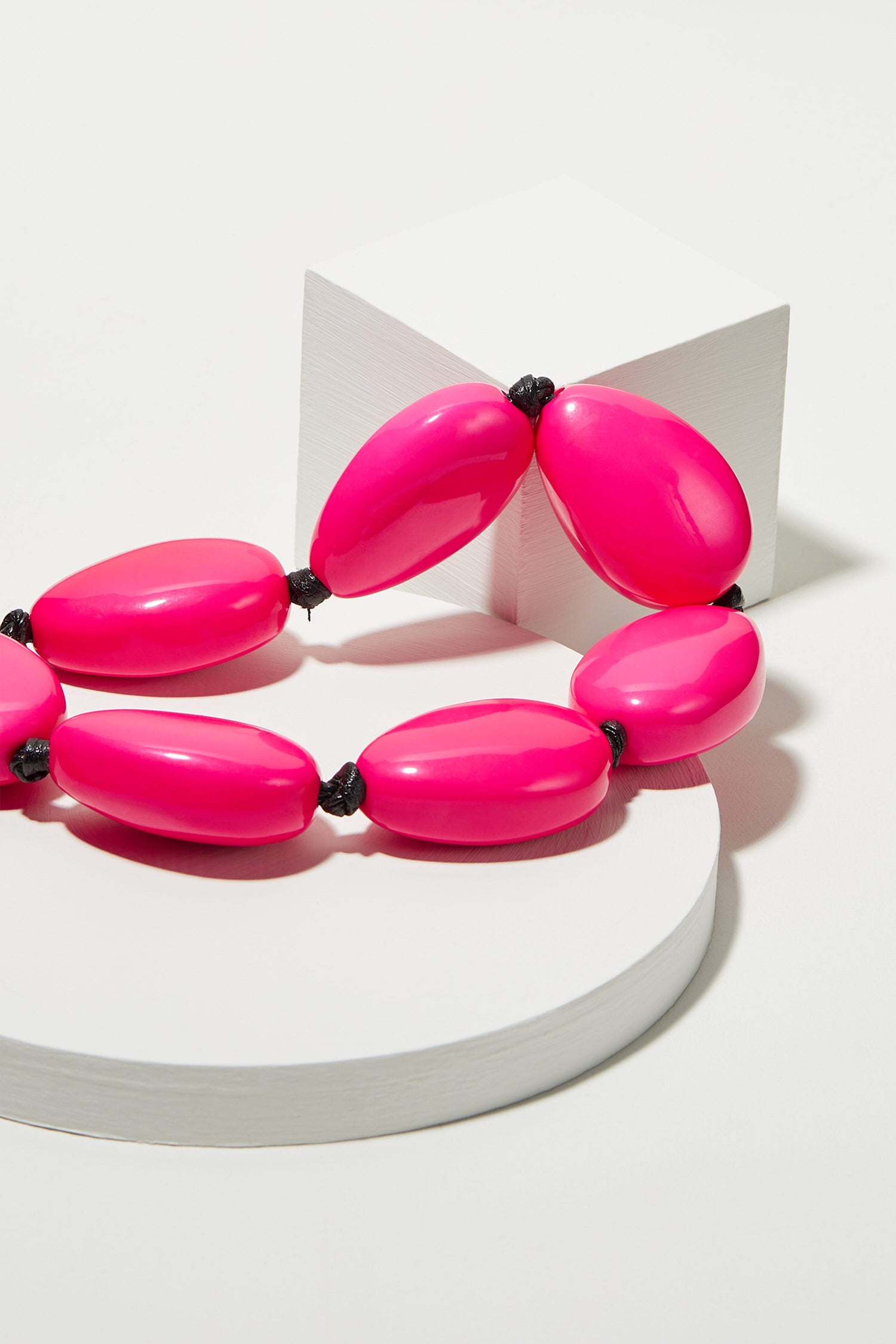 A unique Vibrant Bead Necklace with black beads on a white surface.
