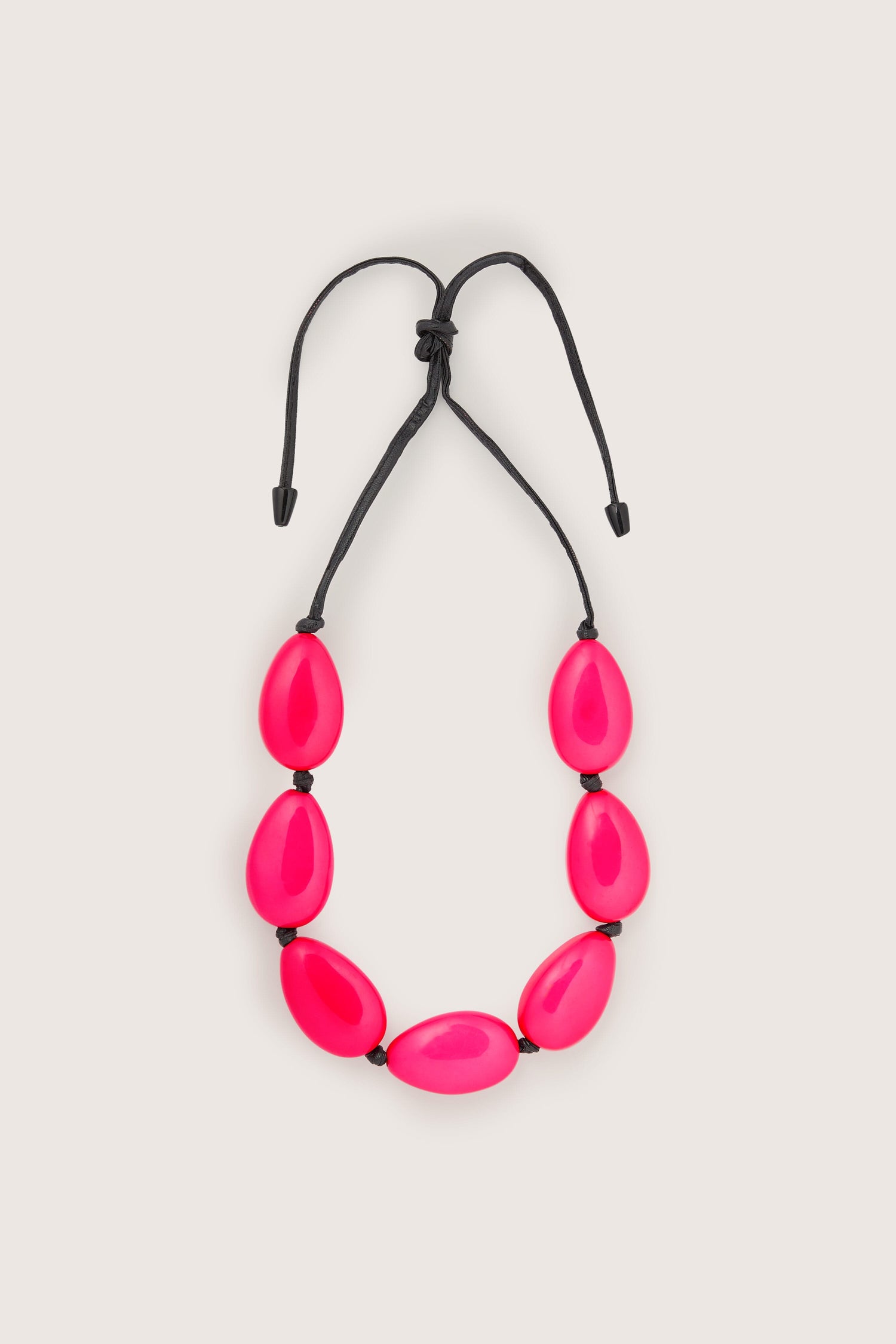 A unique Vibrant Bead Necklace with black beads and a black cord.
