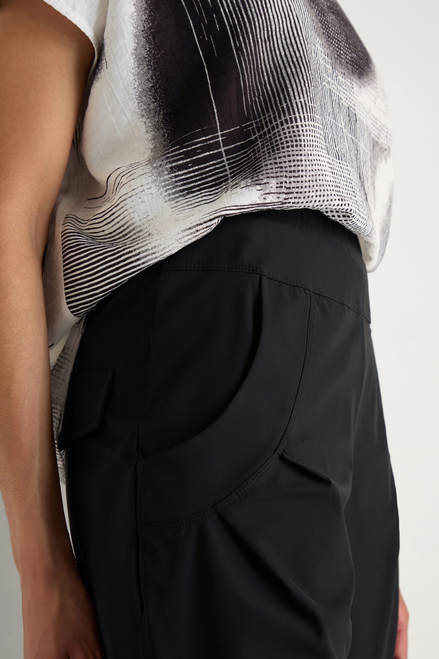 A person wearing Tapered Cuff Trousers with their right hand in the pocket, shown from waist down against a plain background.