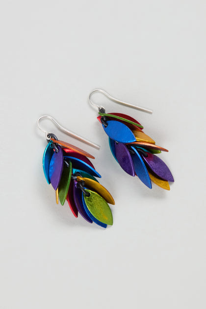 The Rainbow Scattered Leaves Earrings showcase layered metal leaves in blue, green, purple, red, and gold—ideal for lovers of contemporary jewellery.