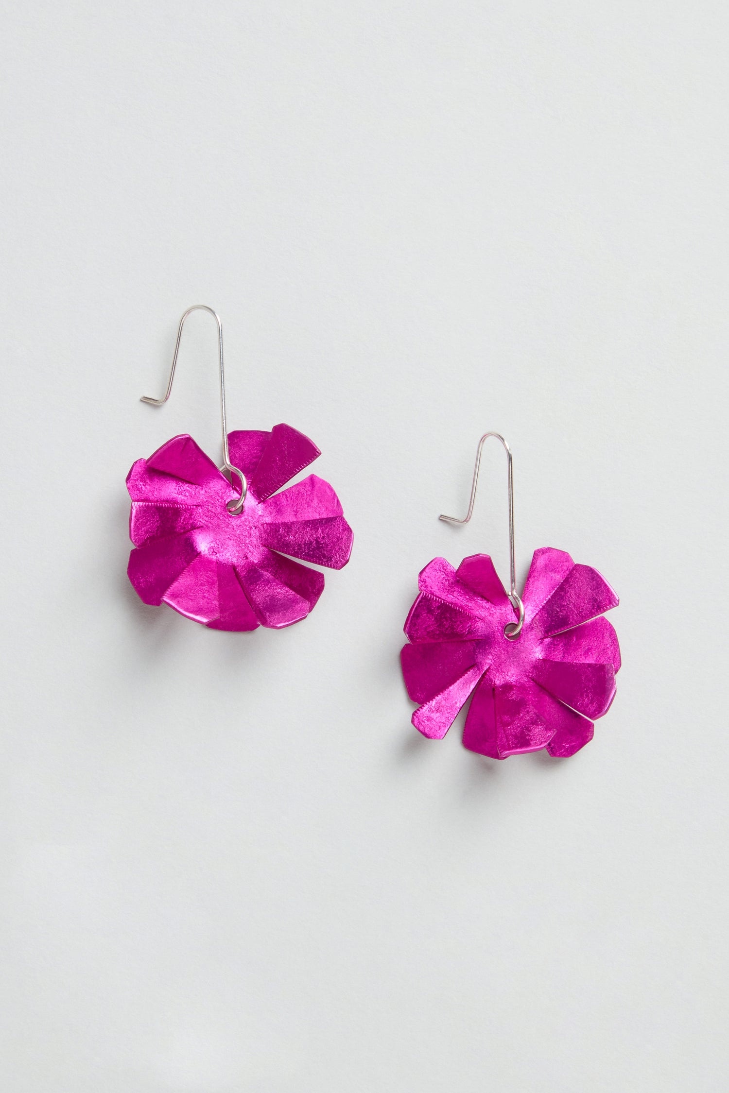 Flower Earrings featuring bright pink, layered petal-shaped designs with sterling silver hooks, shown against a light background.