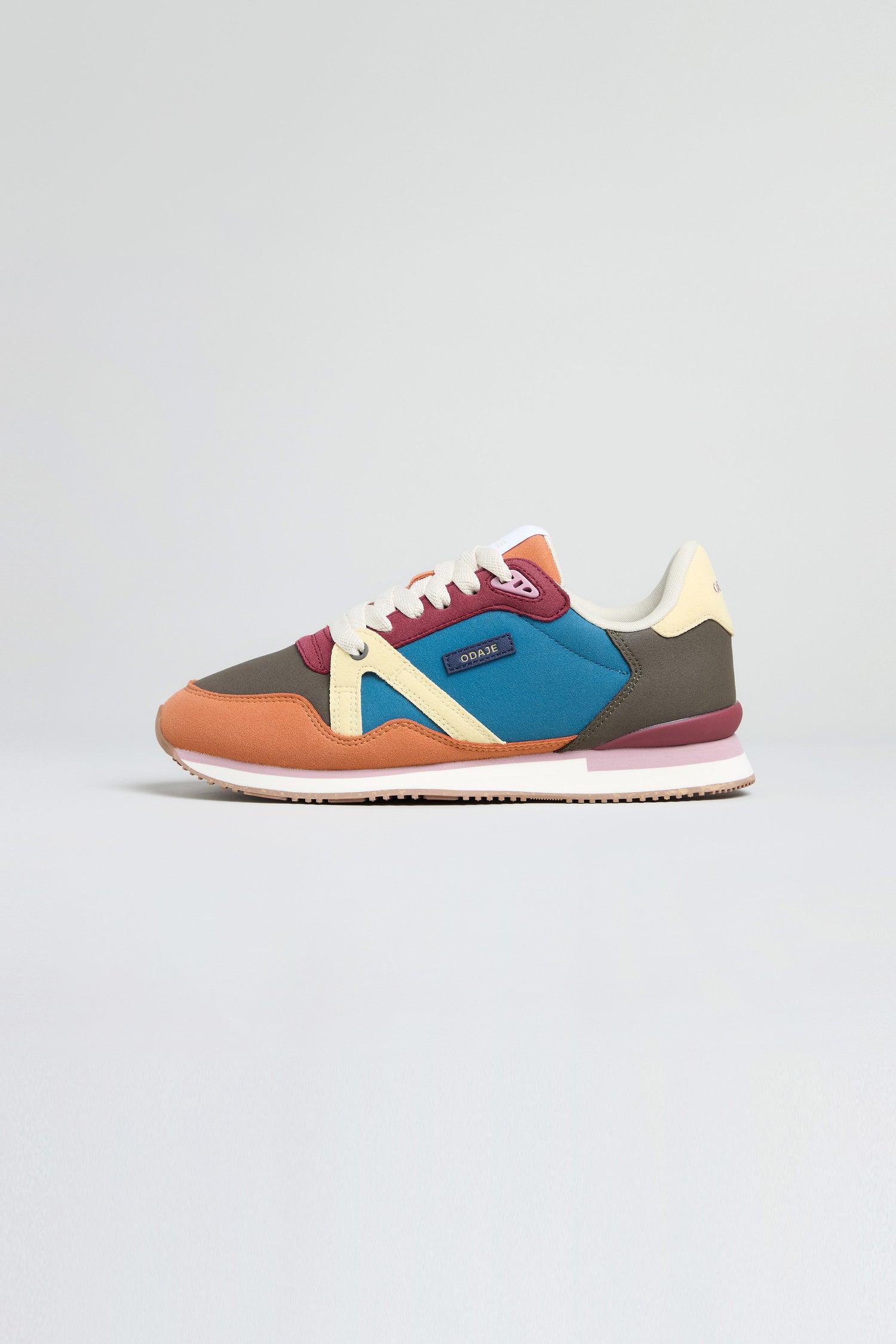 The Colour Pop Andree Trainers feature bold colour blocking in orange, brown, blue, cream, and maroon with white laces, displayed against a plain light background.