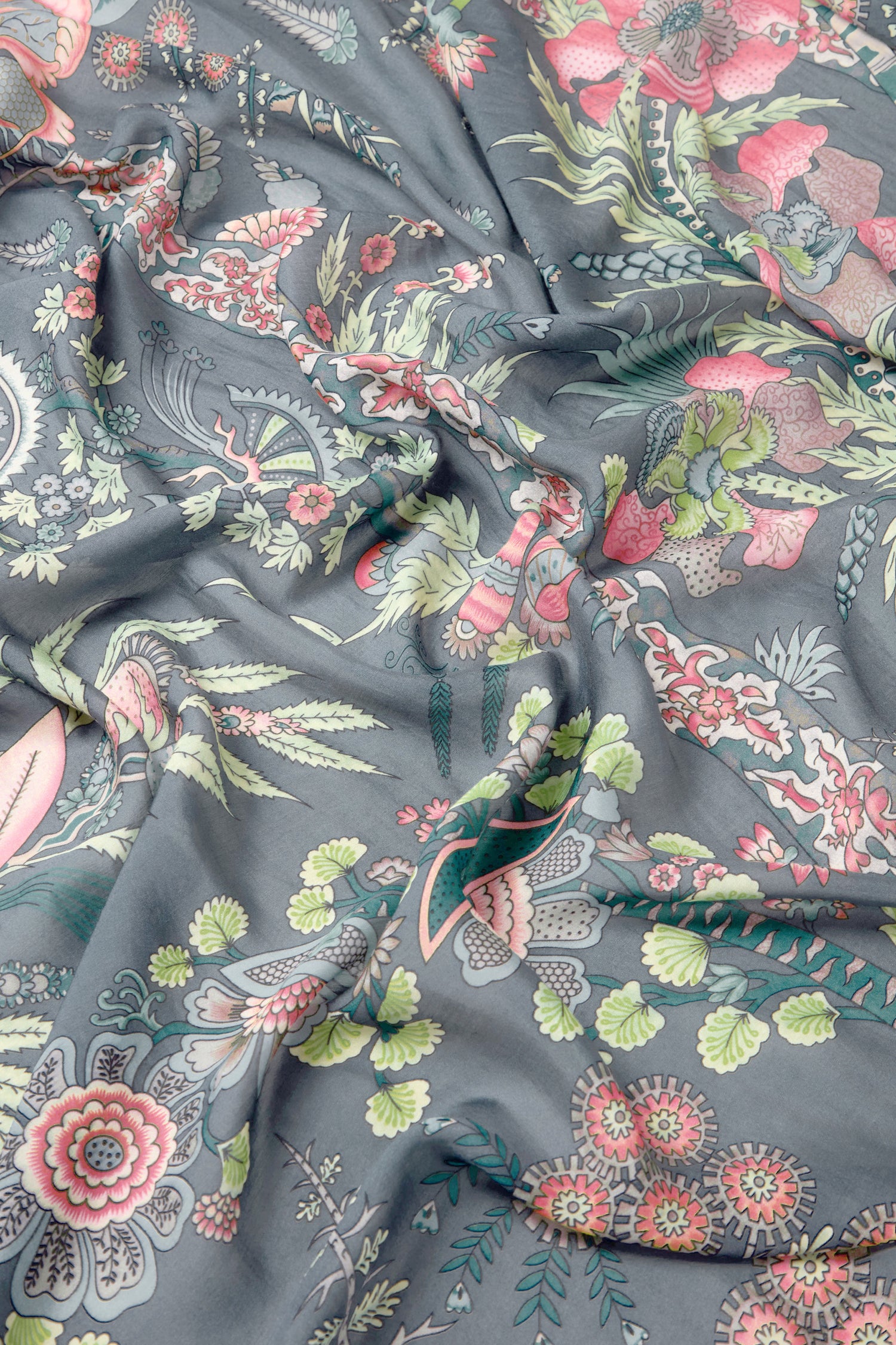 The Boho Garden Print Scarf features a dark, crumpled botanical floral pattern in pink, green, and red hues—perfect as a lightweight accessory made from sustainable fabric.