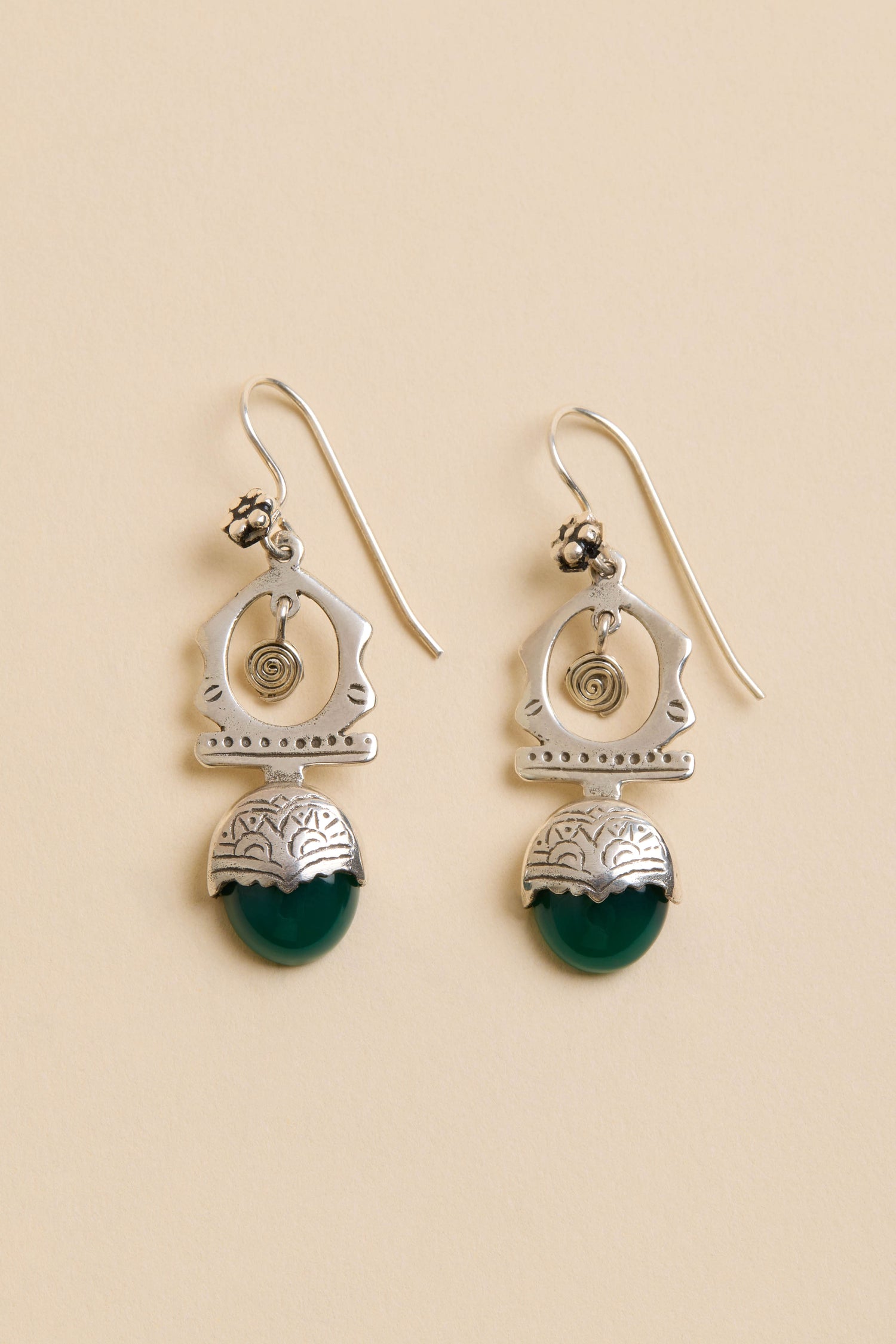 Green Onyx Drop Earrings: Sterling silver drops with spiral and geometric designs and green semi-circular stones, shown on a beige background.