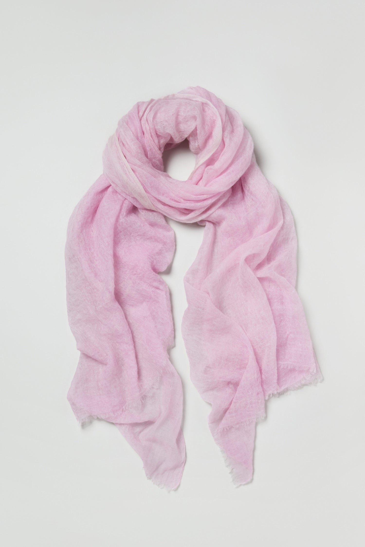 Soft Blush Cashmere Scarf made from lightweight, sheer cashmere, shown laid flat on a white background with ends elegantly draped—a versatile accessory for any season.