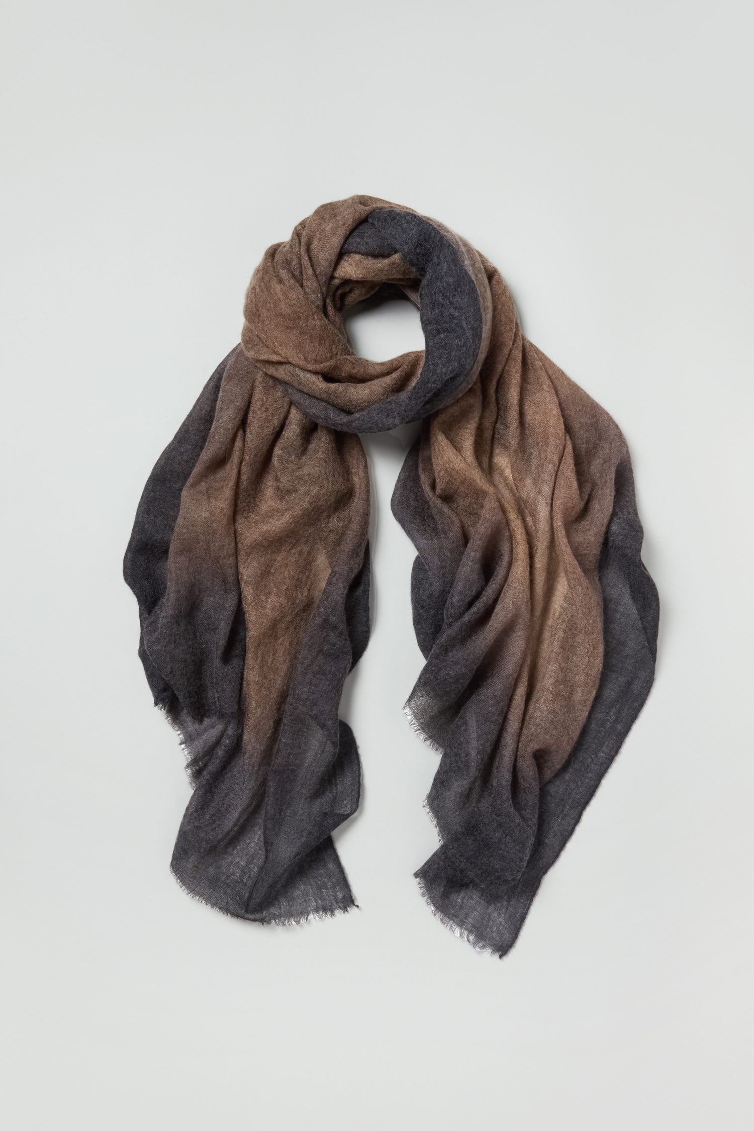 The Airbrush Gradient Cashmere Scarf is a luxury accessory featuring a brown-to-dark gray gradient, crafted from soft cashmere and presented flat against a light background.
