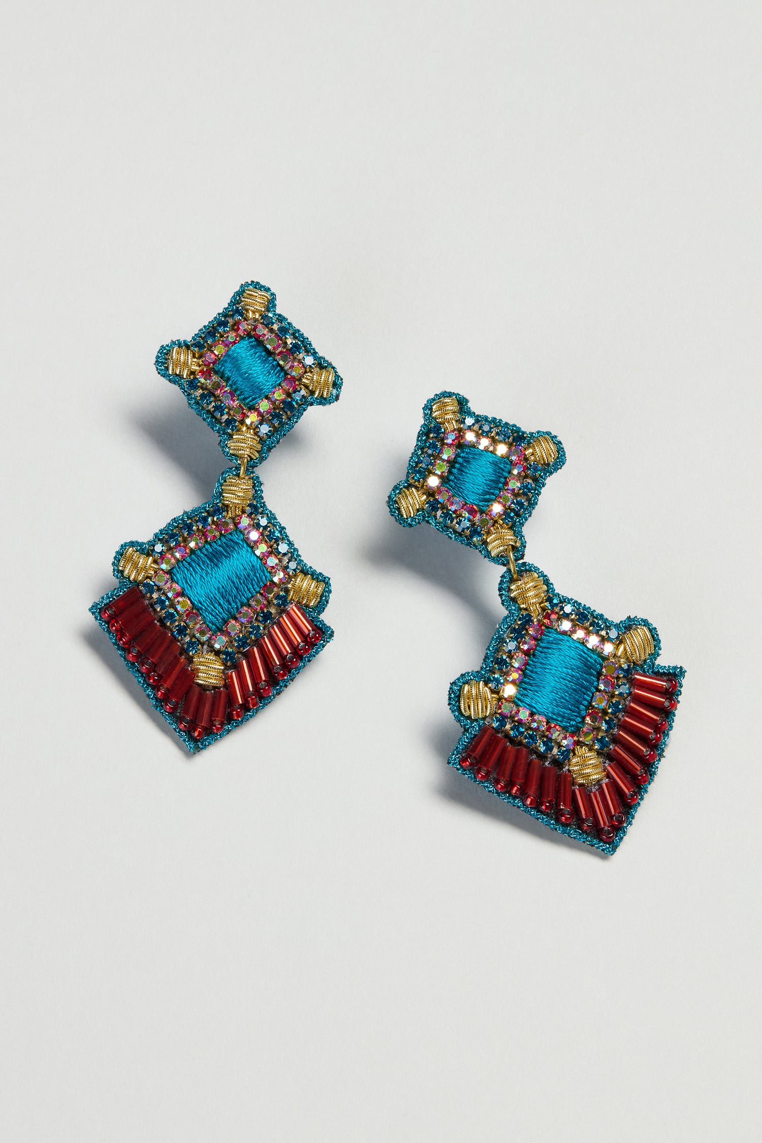 Hand Embroidered Square Drop Earrings with blue thread, red beads, and gold accents in geometric patterns on a white base.
