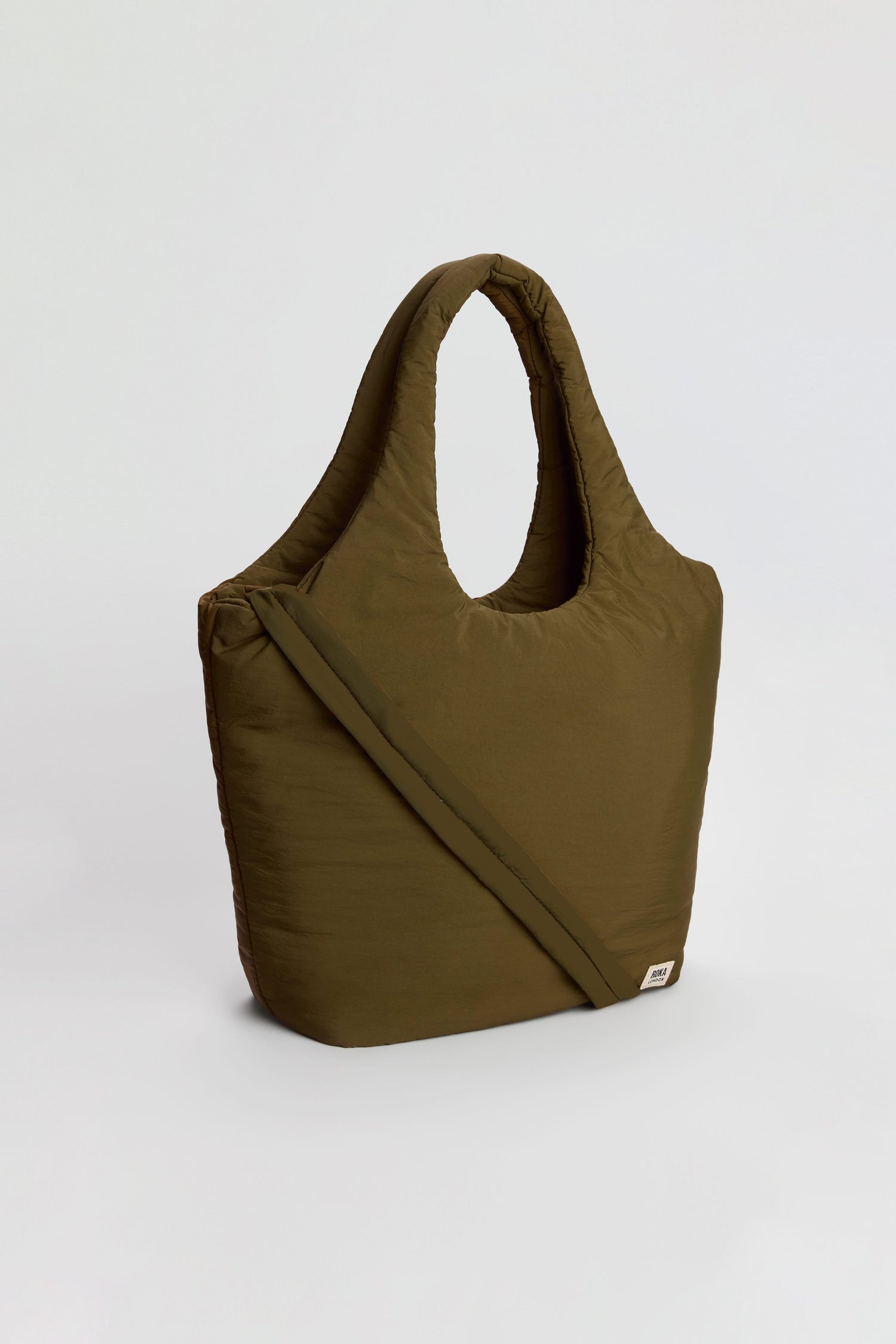 The Oxford Moss Shoulder Bag, crafted in olive green with a quilted, weather-resistant finish, features a shoulder strap, round handles, and a padded laptop sleeve, displayed against a plain light background.