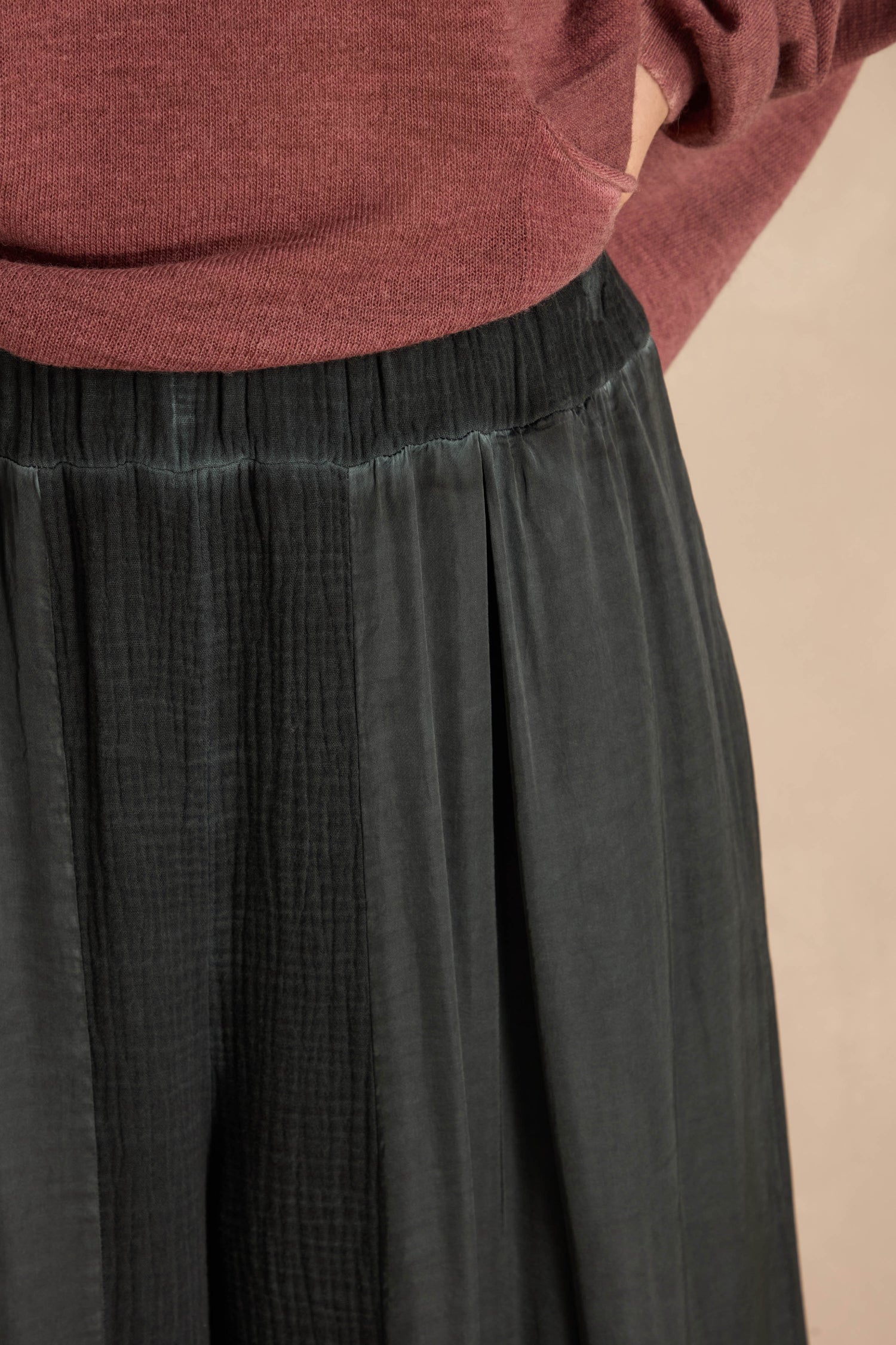 Petrol Wide Leg Panel Trousers in dark green with a wide-leg fit and gathered elastic waistband, styled with a maroon sweater.