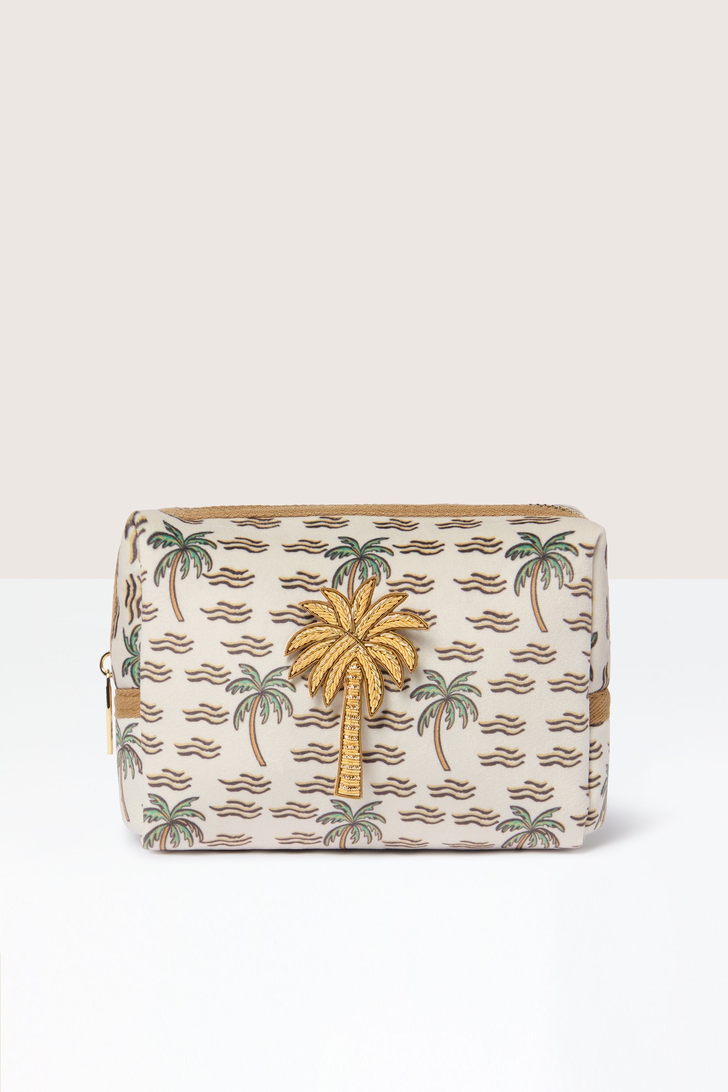 The Large Palm Make-up Bag exudes tropical elegance with its gold palm tree design set against a beige background, and it features a convenient zipper on top.