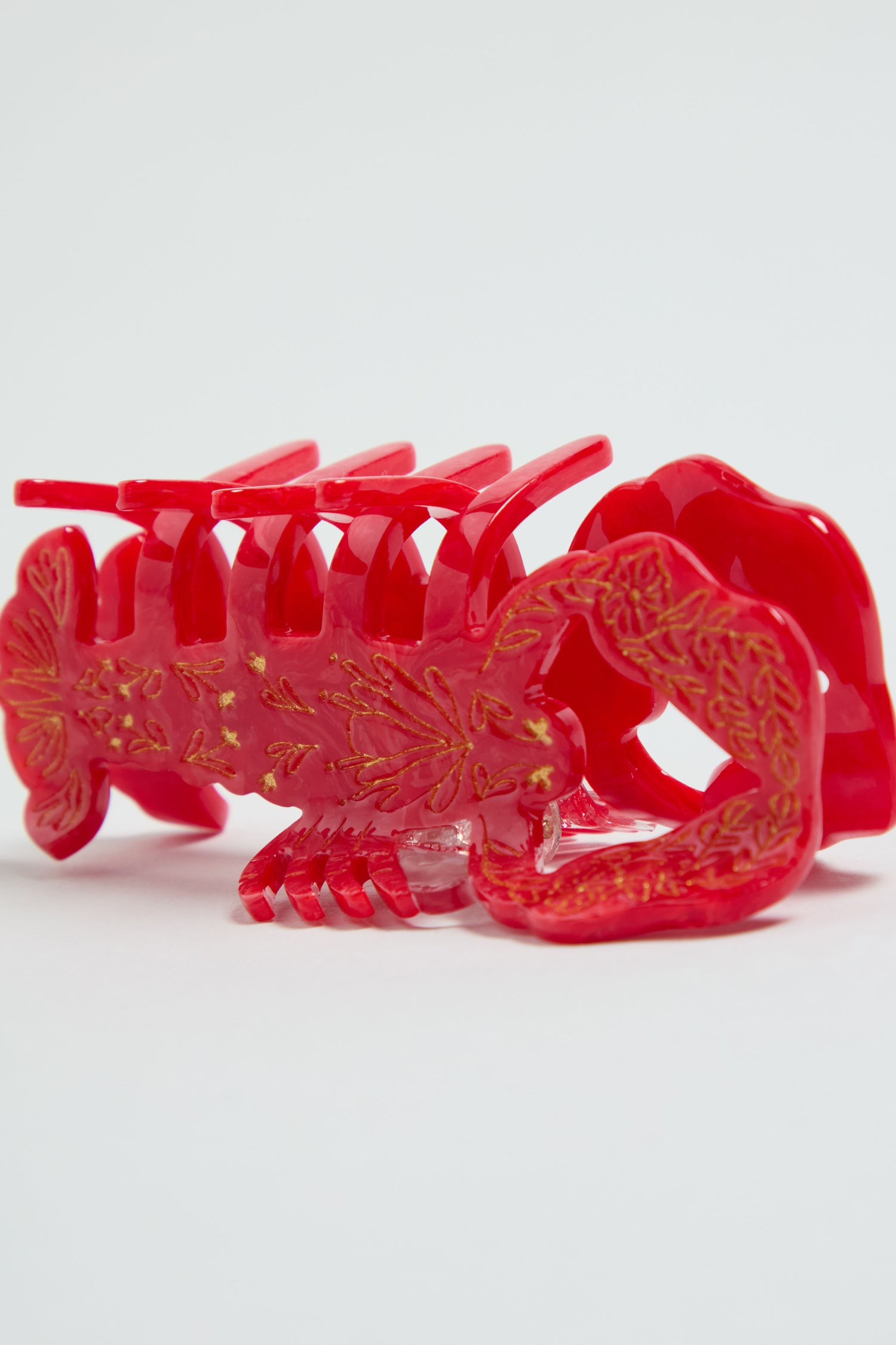 The Hand-painted Lobster Hair Clip features gold detailing and a vibrant red finish, ideal for coastal accessories lovers, shown on a plain white background.