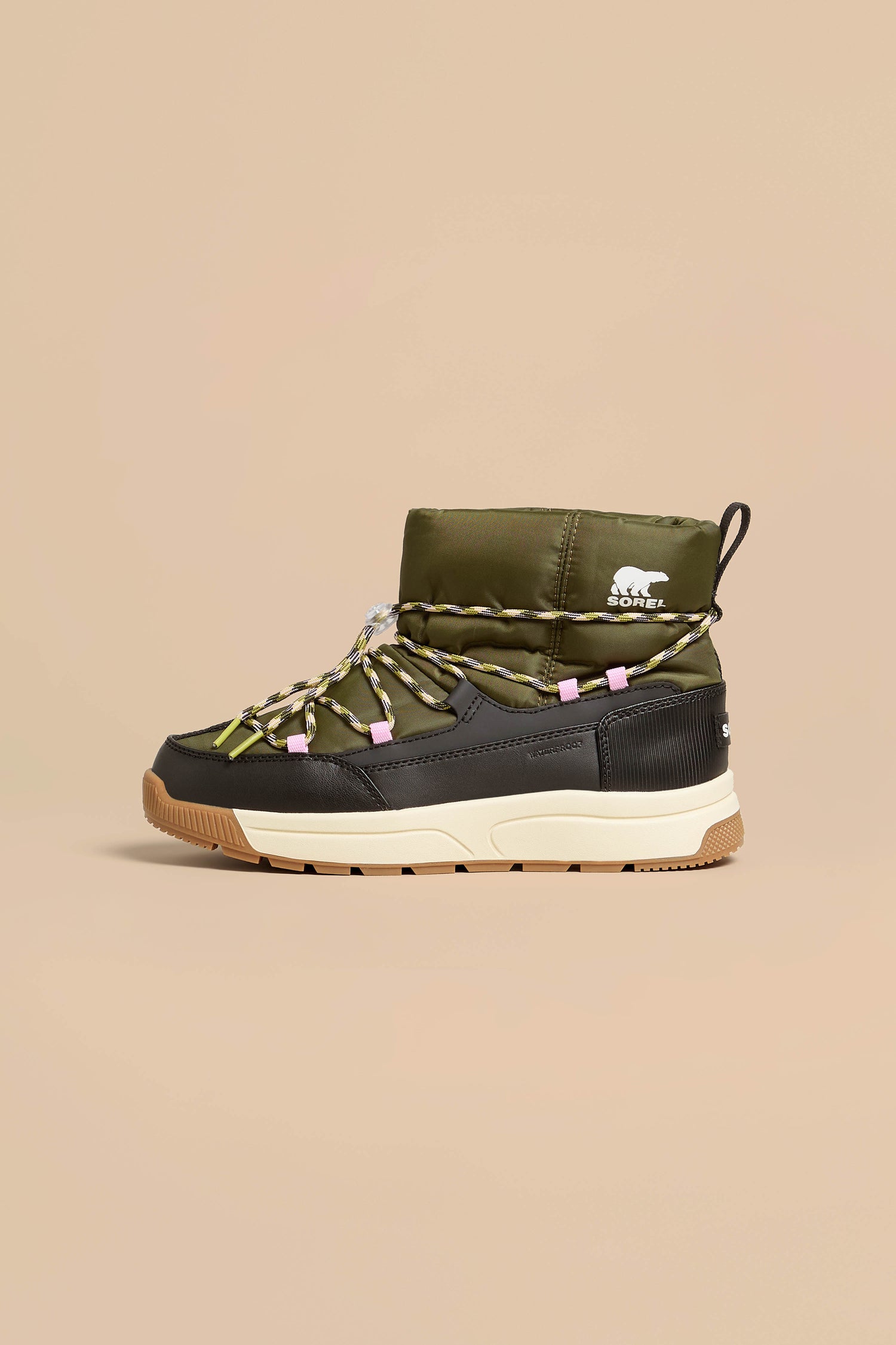 Whitney Quilted Toggle Slip on Boots in olive green with black trim, tan lugged soles, and decorative rope laces.