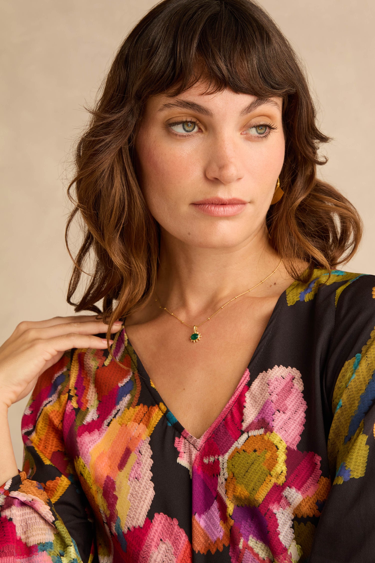 Close-up of a person wearing a Pixelated Floral Flared Dress with a vibrant, multicolored abstract pattern and a flared silhouette.
