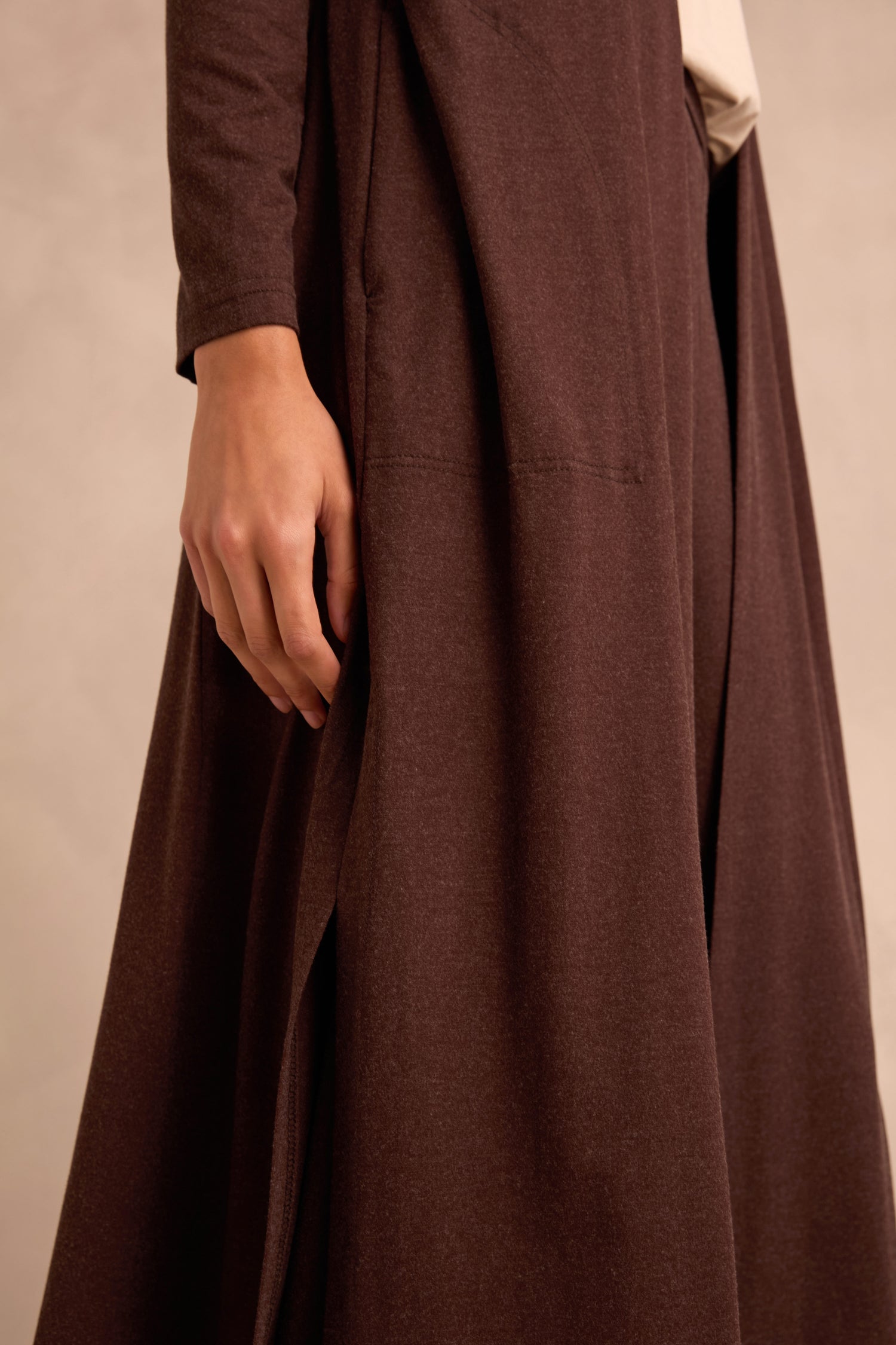 A person wearing the Soft Viscose Jersey Long Line Cardi in a dark brown shade, styled with their left hand resting by their side. The background is plain and neutral.