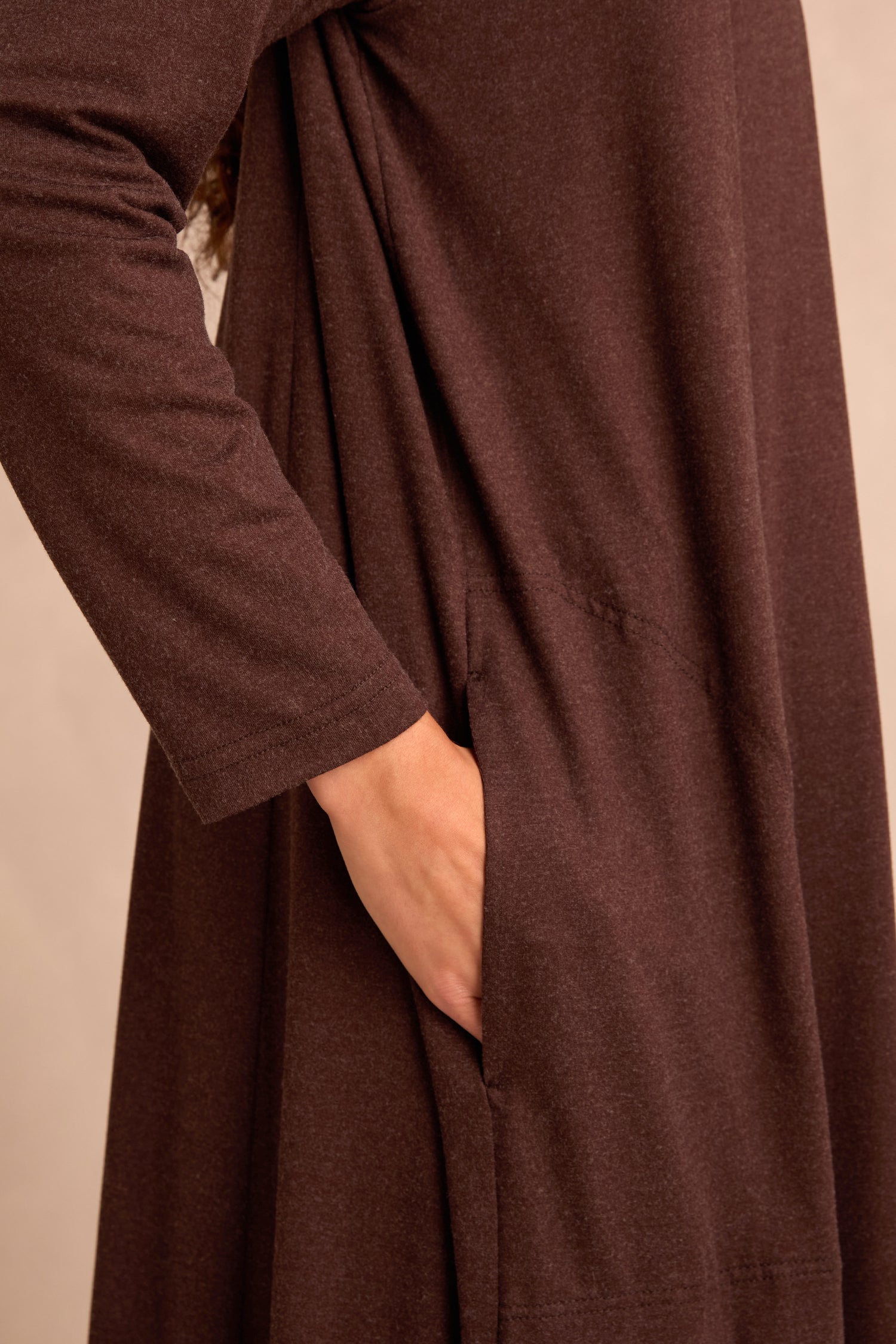 A person wearing the Soft Viscose Jersey Long Line Cardi with long sleeves and a kimono-style drape has their hand placed inside a side pocket.