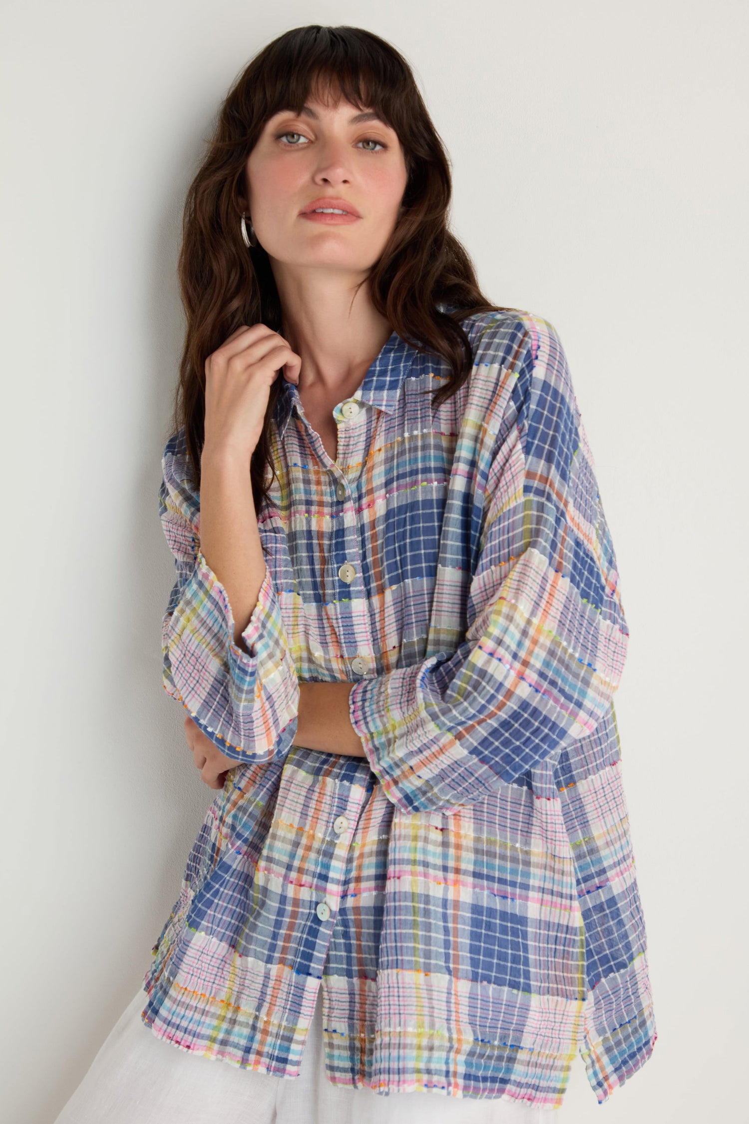 A woman wears the Crinkle Check Jacquard Shirt—a loose, cotton-rich, multicolored long-sleeve shirt with a boxy fit—standing against a plain light background.