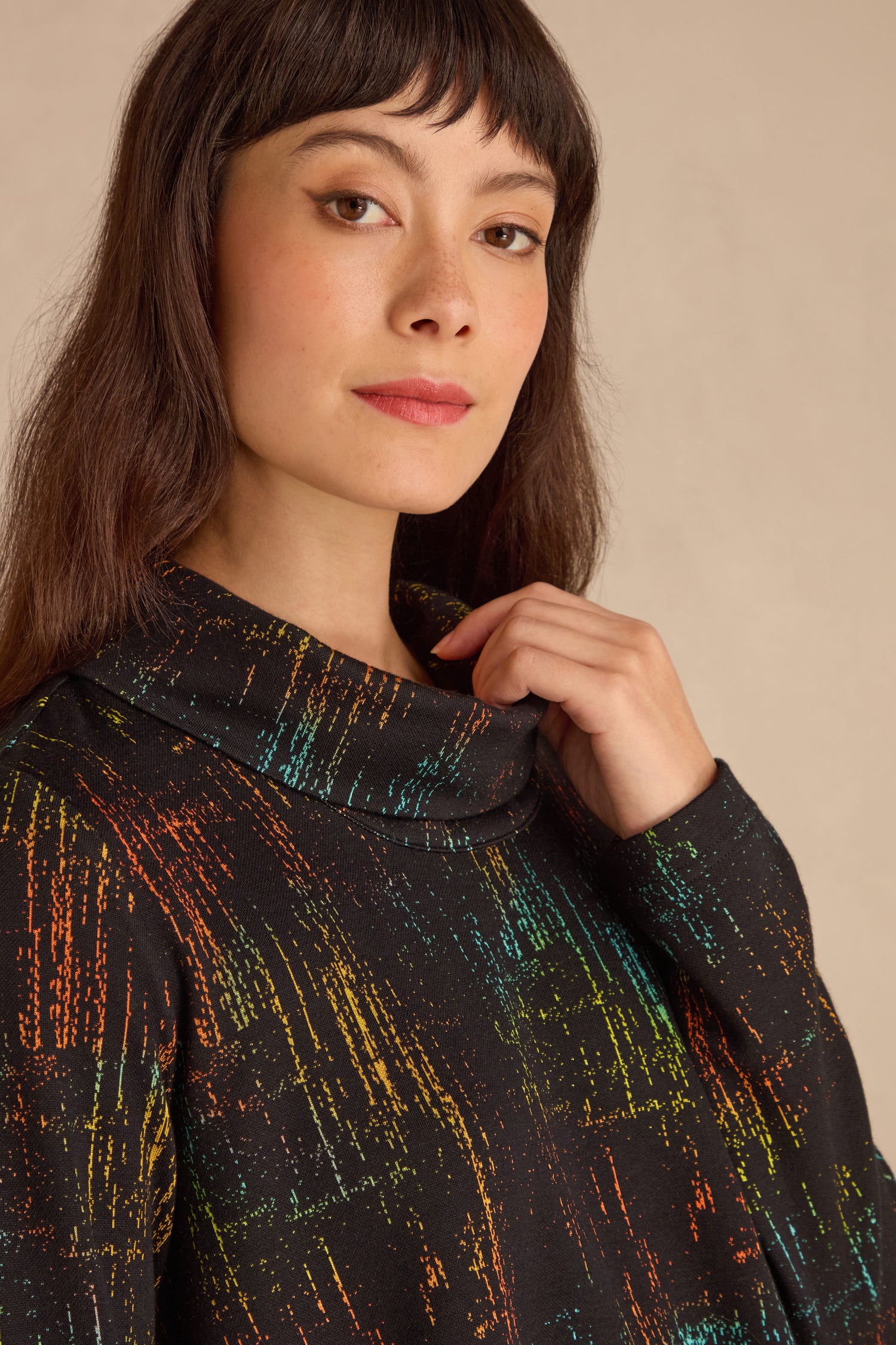 A woman with long brown hair wears the Space Dye Jacquard Jersey Tunic, gazing neutrally at the camera against a plain backdrop.