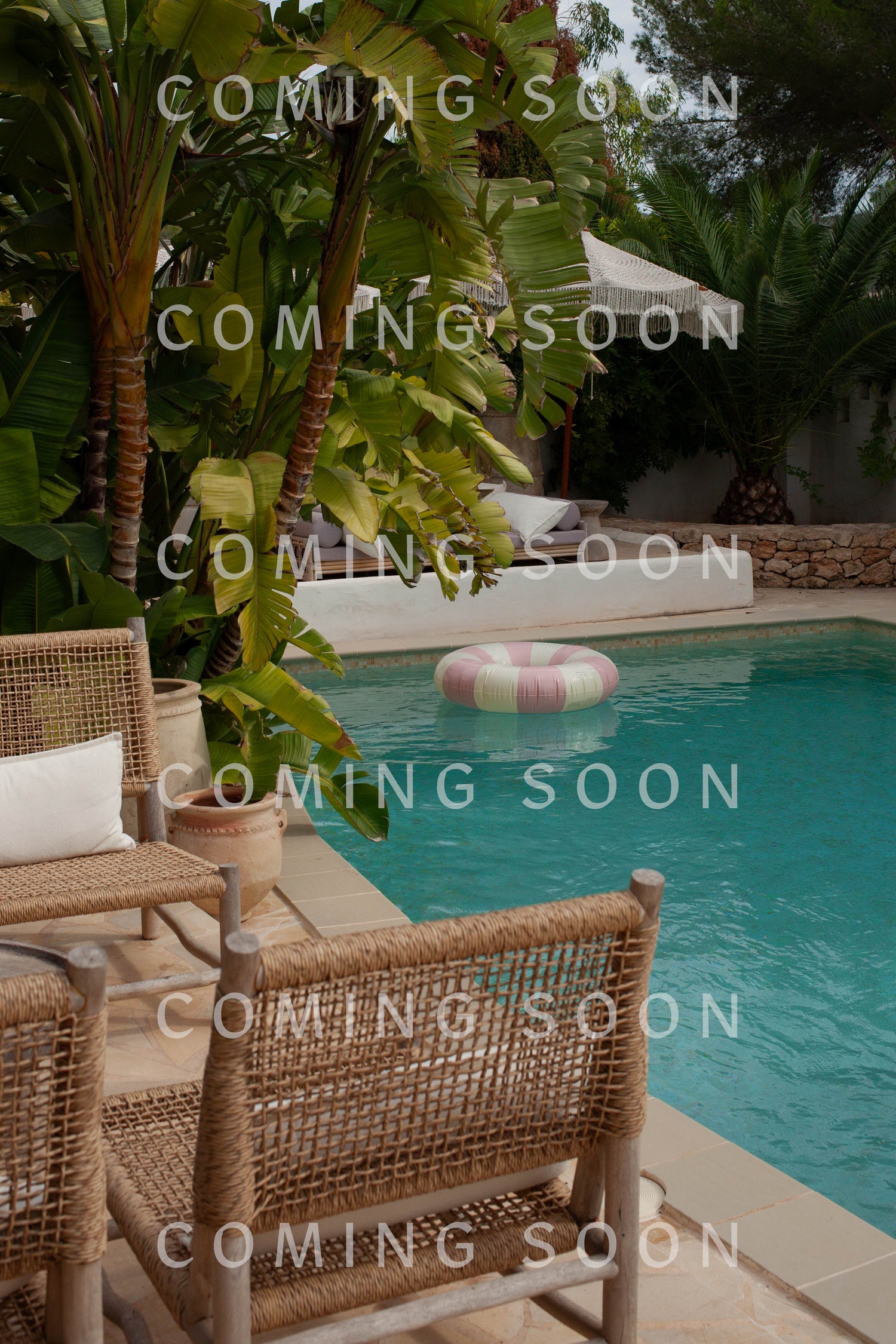 Outdoor pool area with wicker chairs, tropical plants, and a pool float—perfect for relaxing in a Saifu Shirt. Text overlay: "COMING SOON.