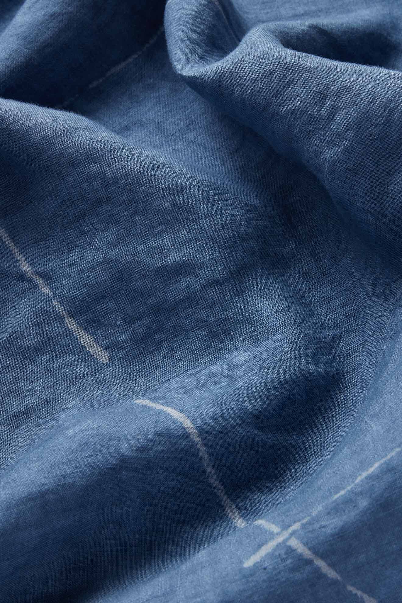 Close-up of Som Linen Dress highlighting eco-friendly linen with subtle white lines, visible texture, and natural creases—ideal for a minimalist sleeveless look or relaxed A-line silhouette.