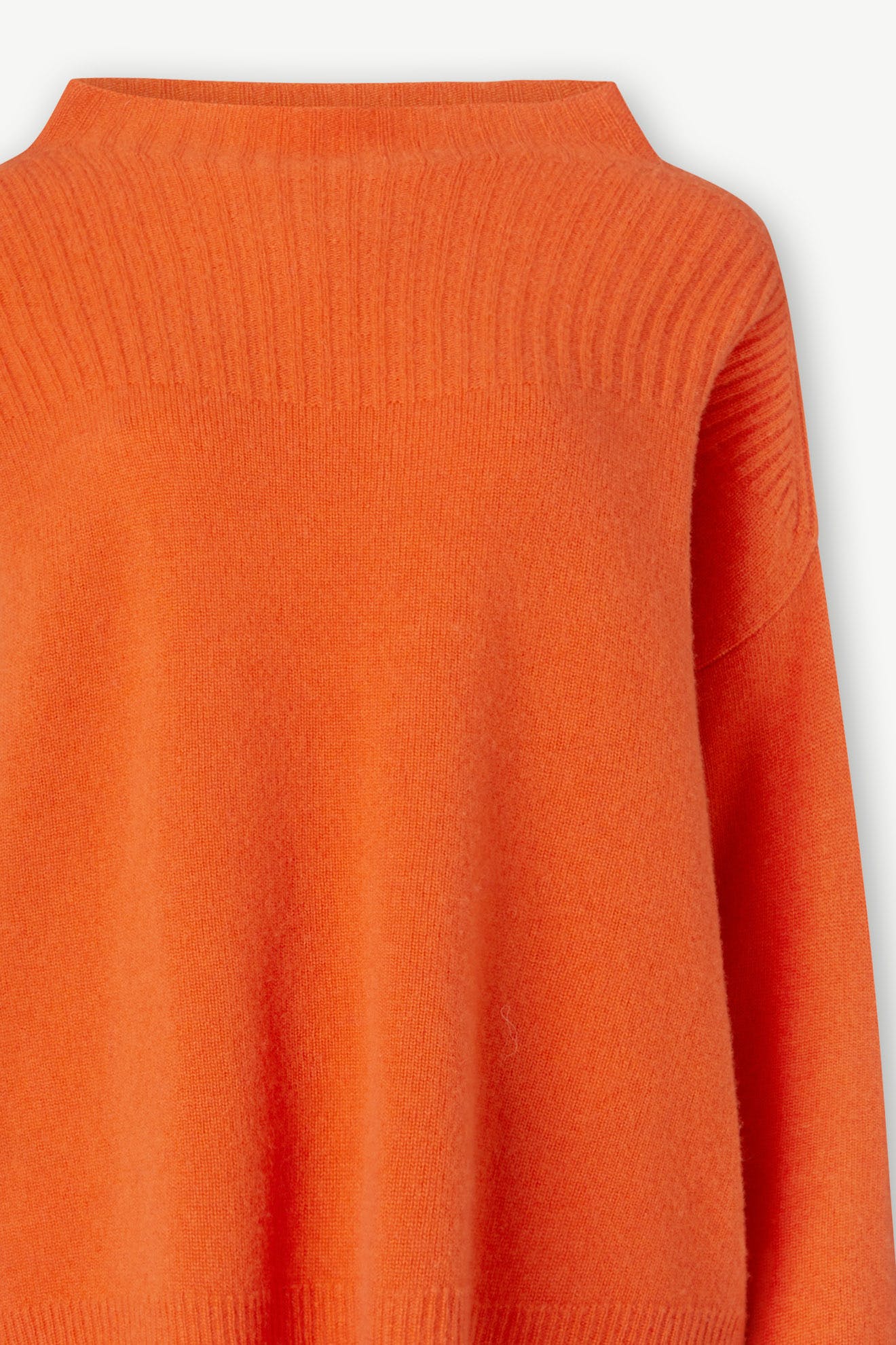 A luxurious Cashmere Blend Rib Turtle Neck in orange, featuring a ribbed neckline and a textured upper section, displayed on a plain white background.