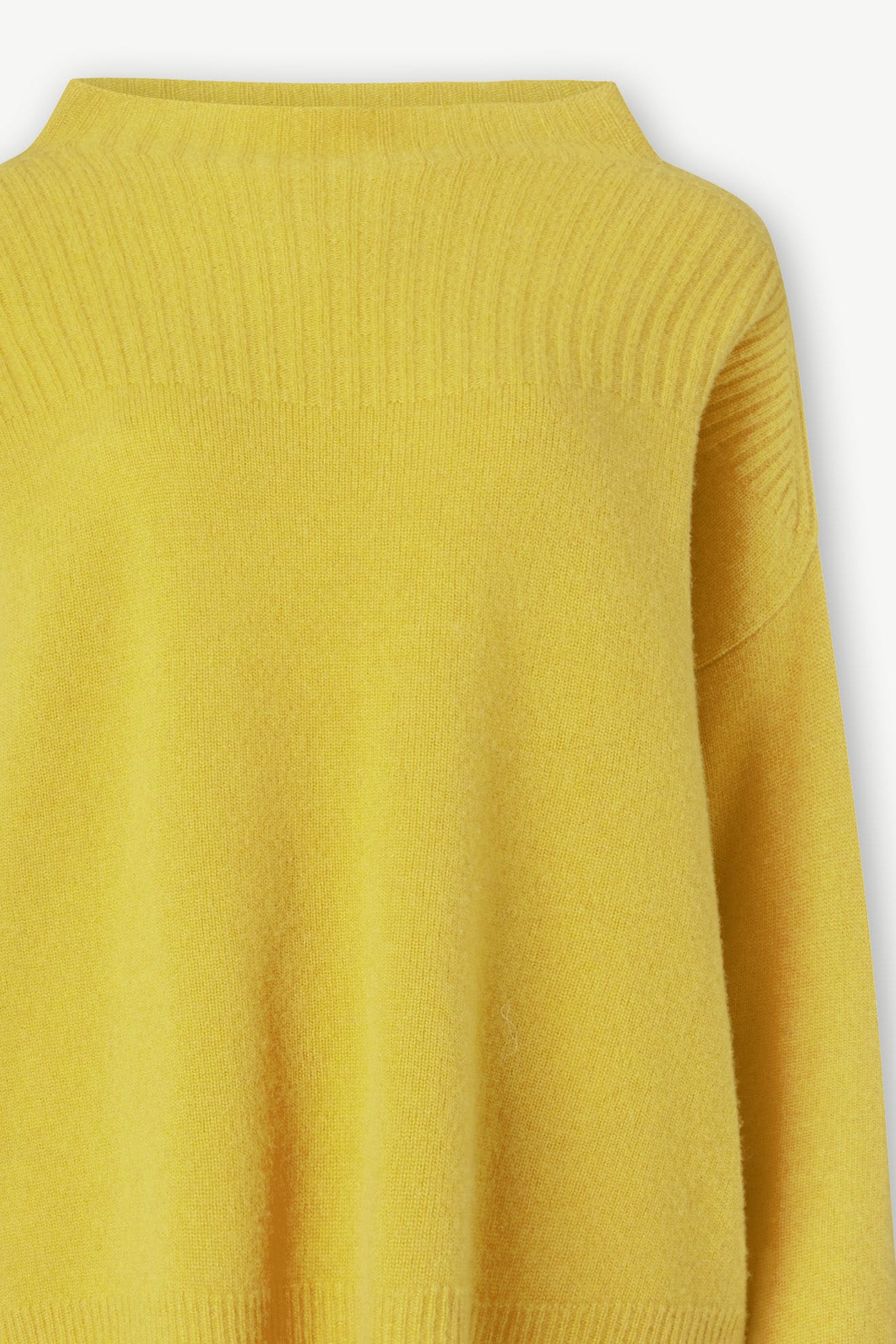 Close-up of a Cashmere Blend Rib Turtle Neck in yellow, featuring a ribbed high neckline and long sleeves, showcasing bright, happy colors that make it an ideal cold-weather staple.