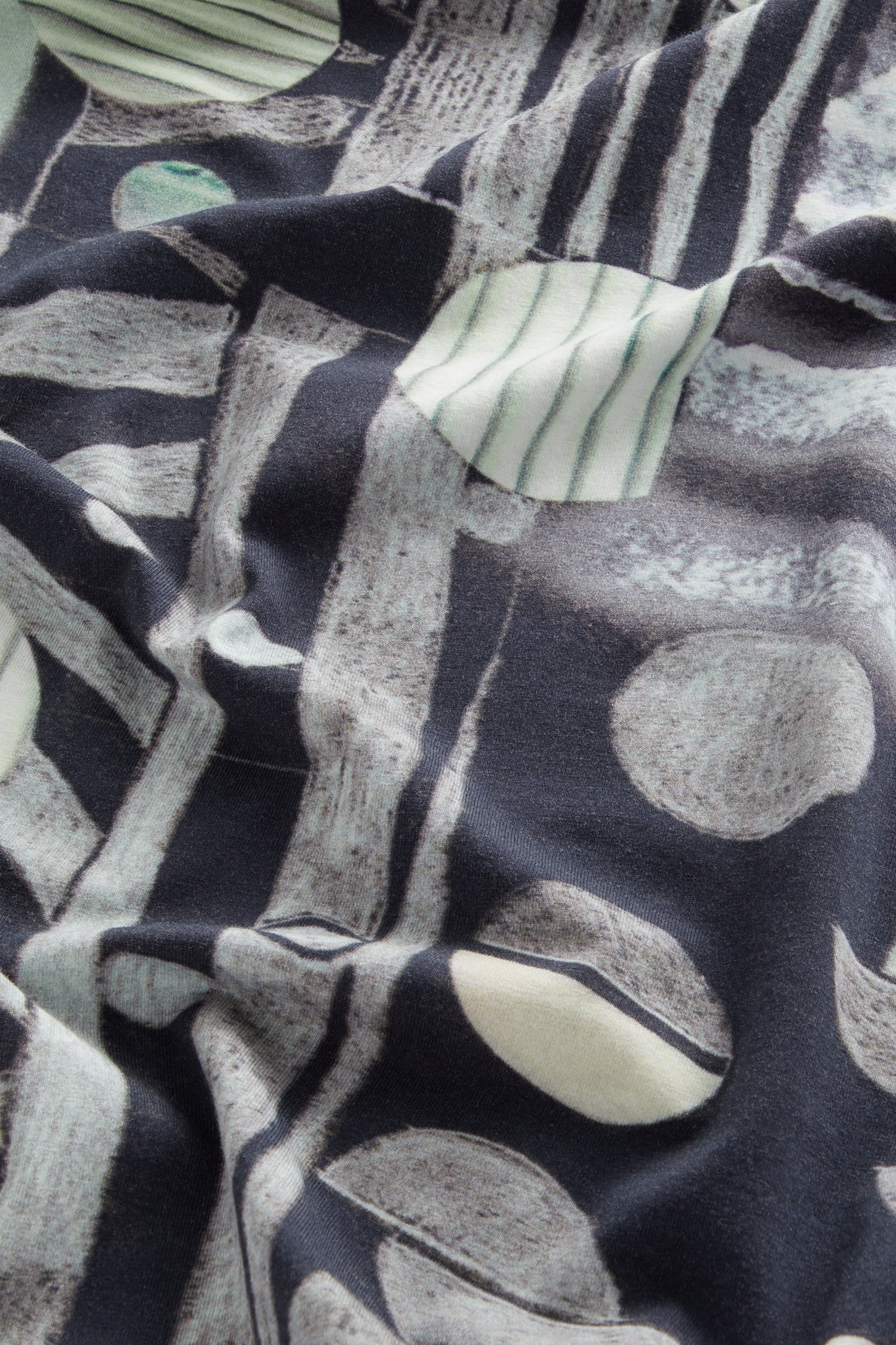 Close-up of a Miro jersey dress fabric with a textured, abstract pattern in shades of blue and white.