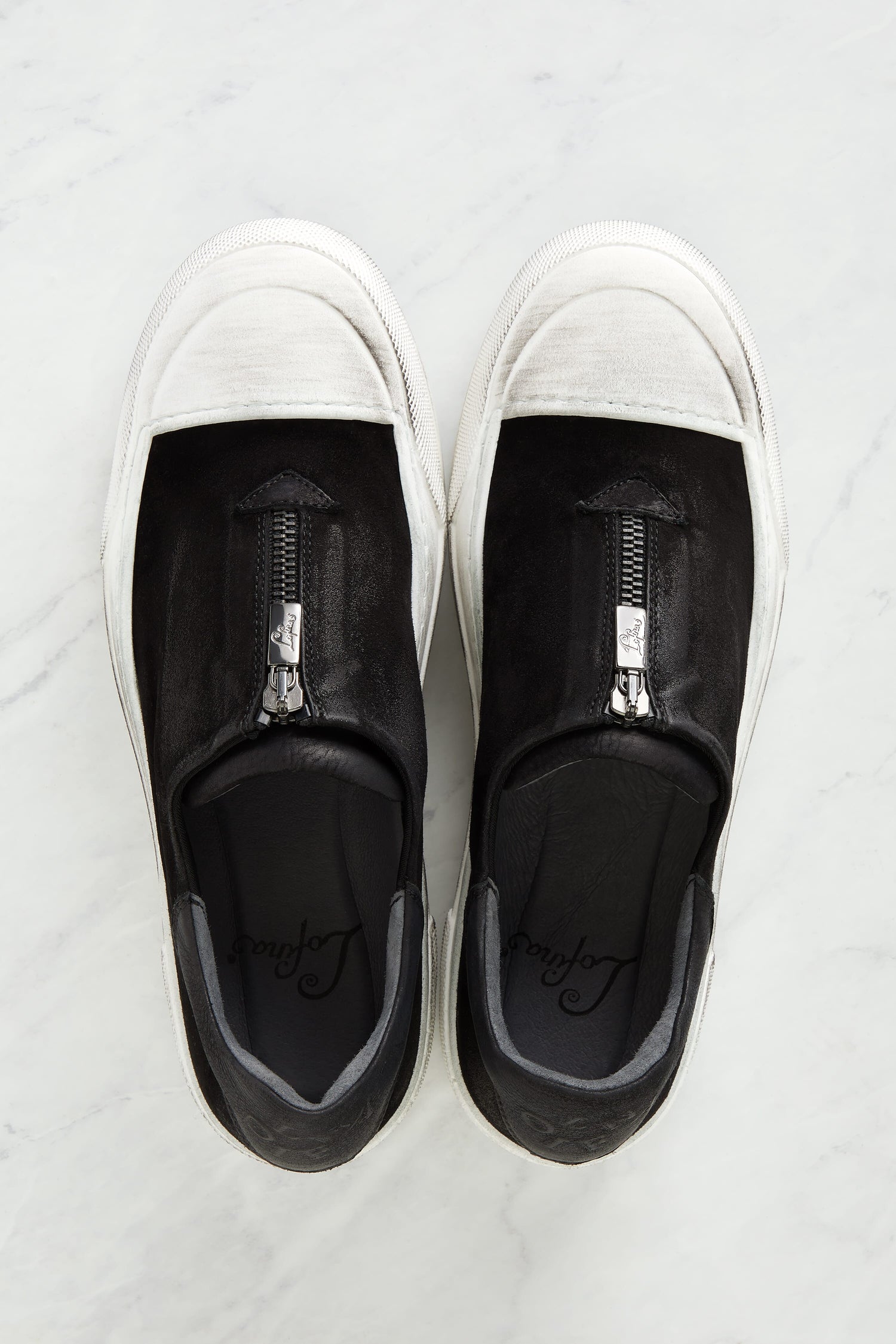 A pair of Zip Detail Suede Pumps by Lofina shoes on a marble surface.