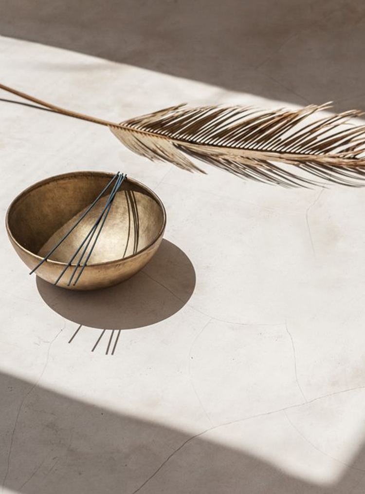 incense in gold bowl and gold feather