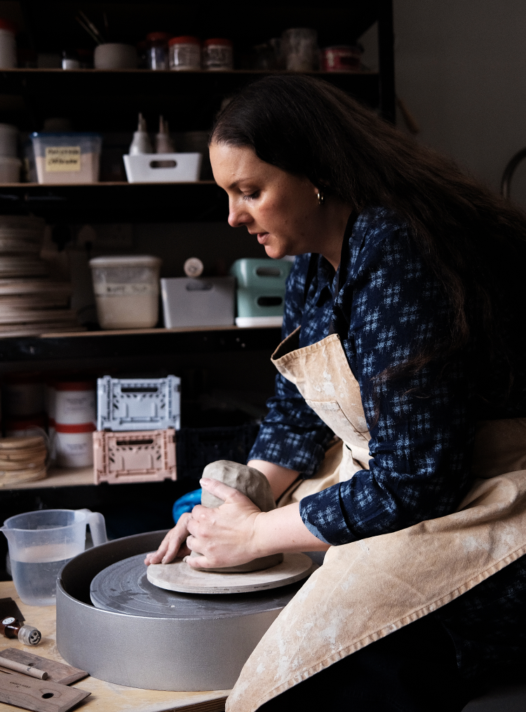 woman making clay pots
