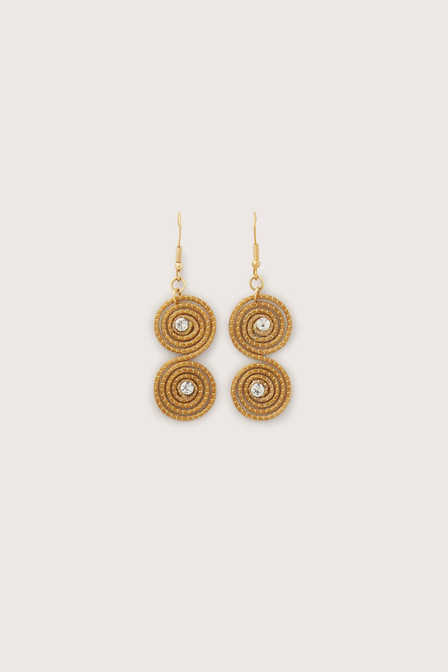 A pair of Golden Grass Spiral Rhinestone Earrings with embedded crystals on a white background.