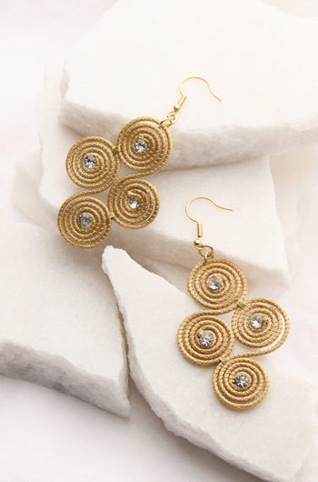 A pair of Golden Grass Woven Spiral Rhinestone earrings with diamonds.