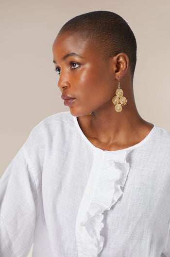 A woman in a white shirt wearing Golden Grass Woven Spiral Rhinestone Earrings.