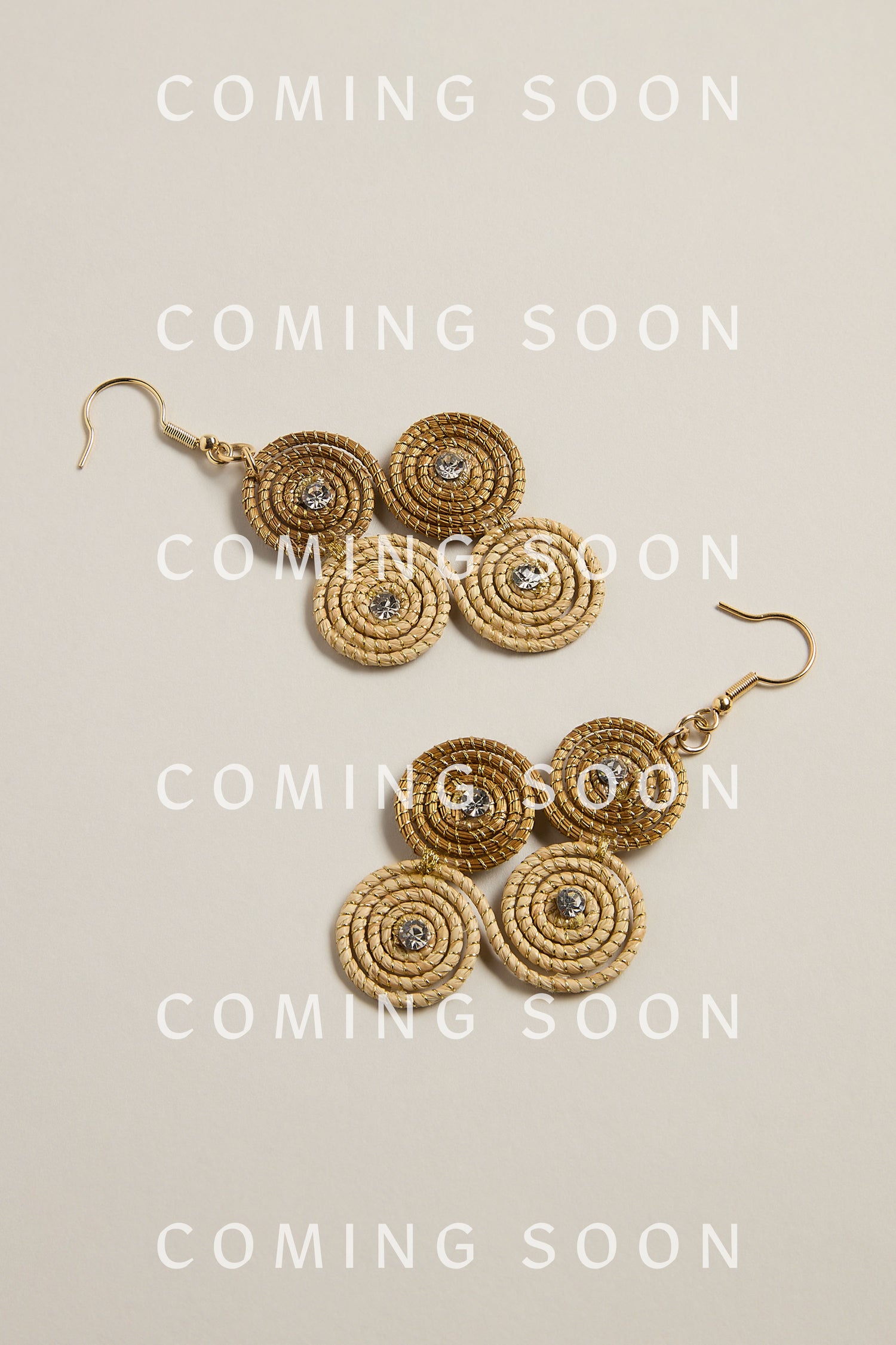 Golden Grass Woven Spiral Rhinestone Earrings with a gold hook, made from sustainable materials, displayed on a light background with the text "COMING SOON.