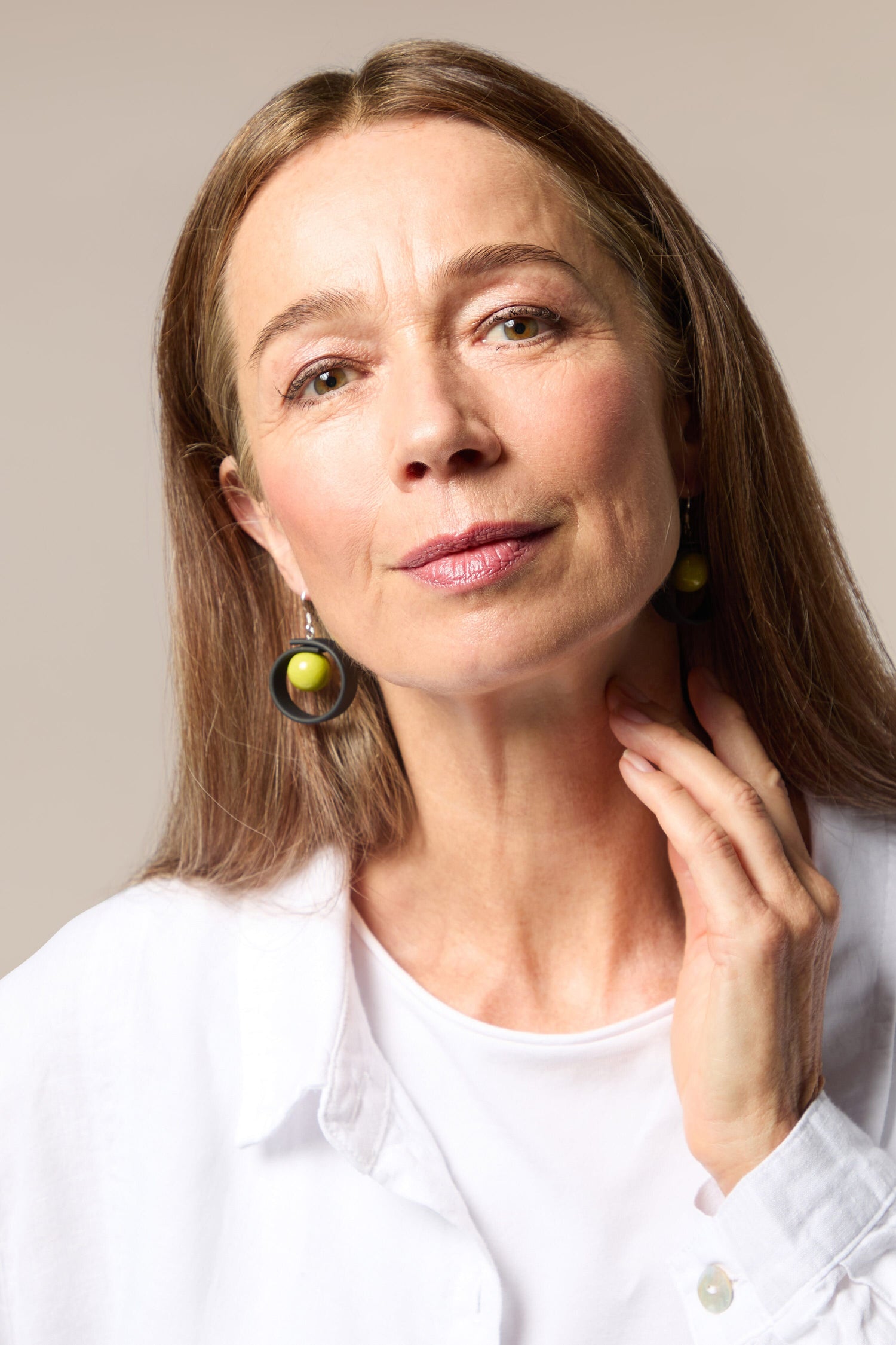 A woman wearing Tempo Earrings.